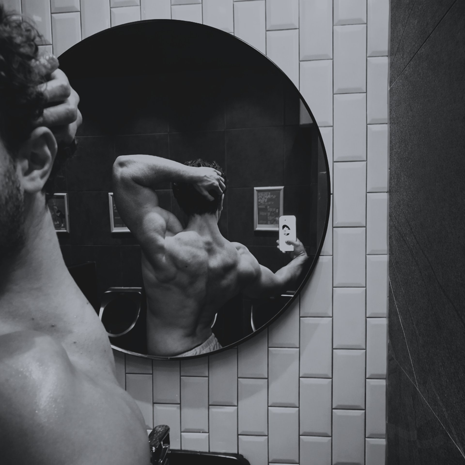 man in black tank top and shorts wearing black mask