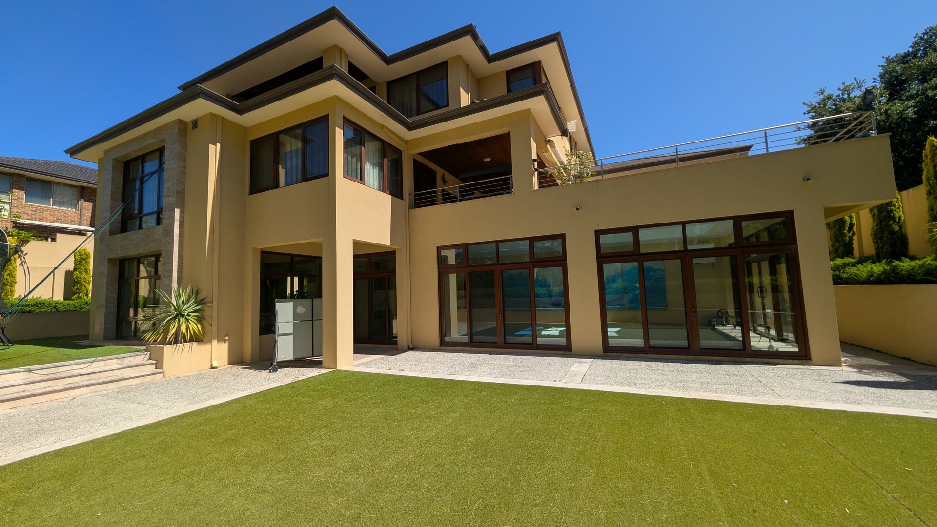 white and brown concrete building near green grass field during daytime