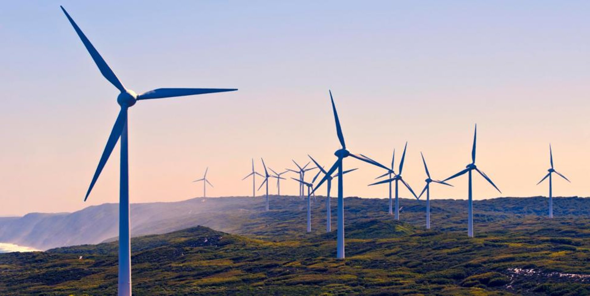 an abstract photo of a curved building with a blue sky in the background