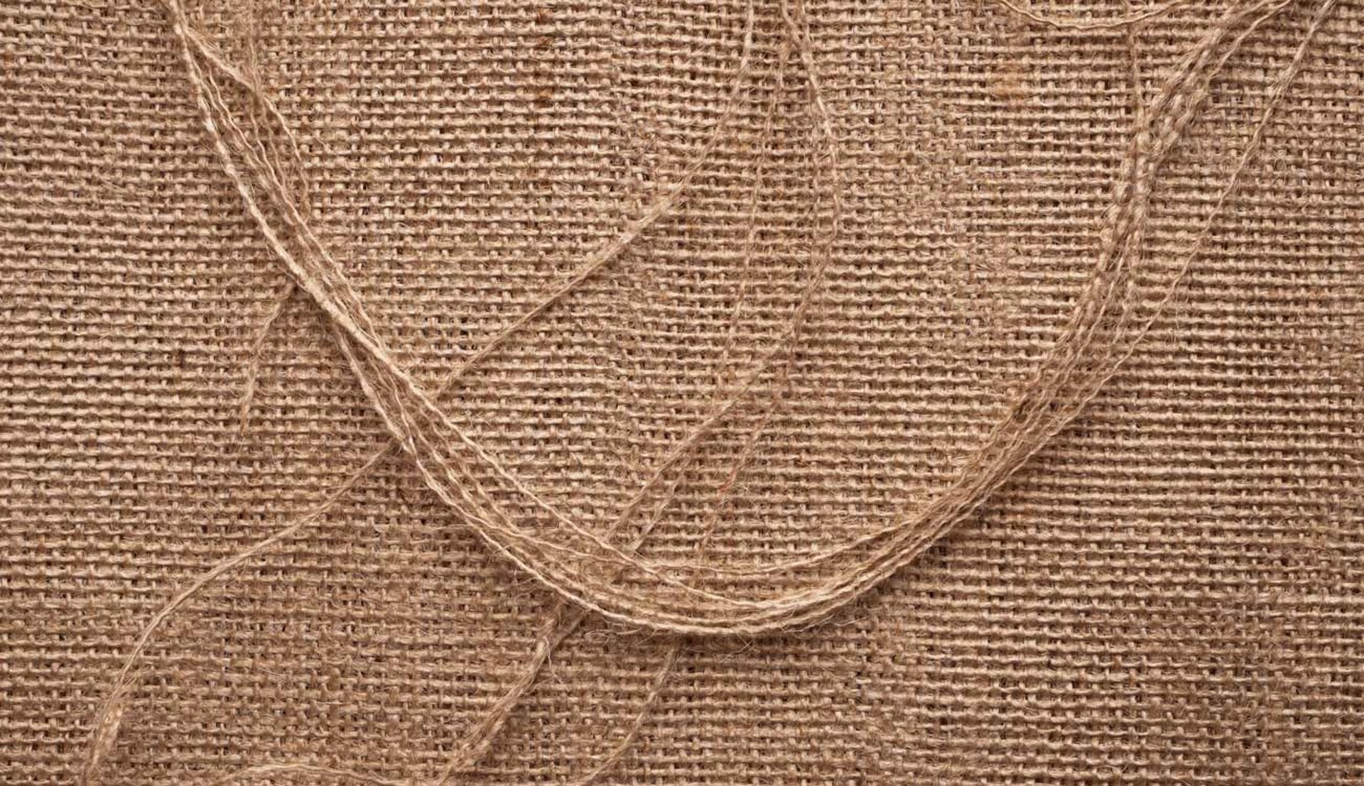 fondo de tela de yute en color beige con hilos deshilachados