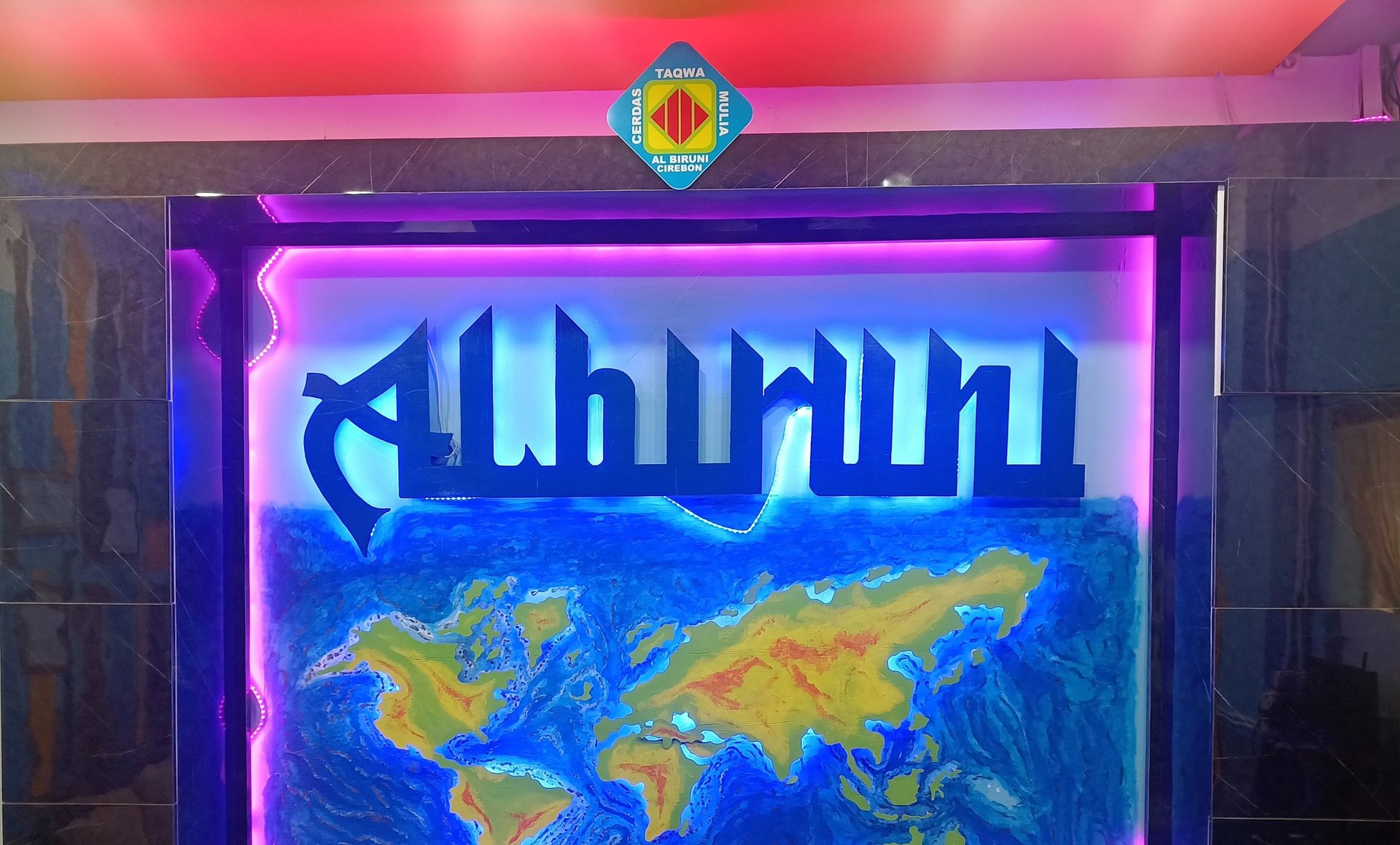 Young woman in hijab sitting outdoors