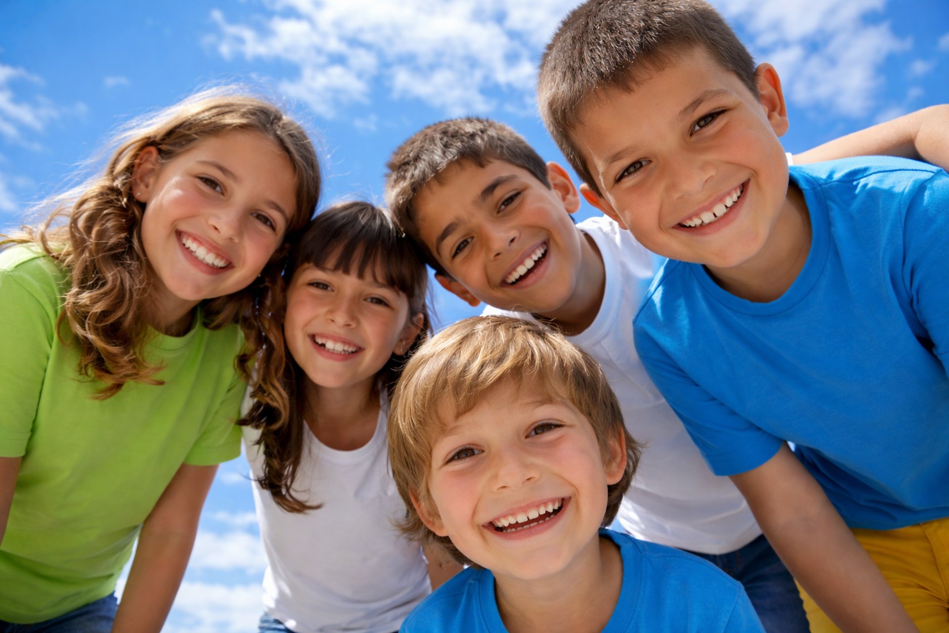 person in red sweater holding babys hand