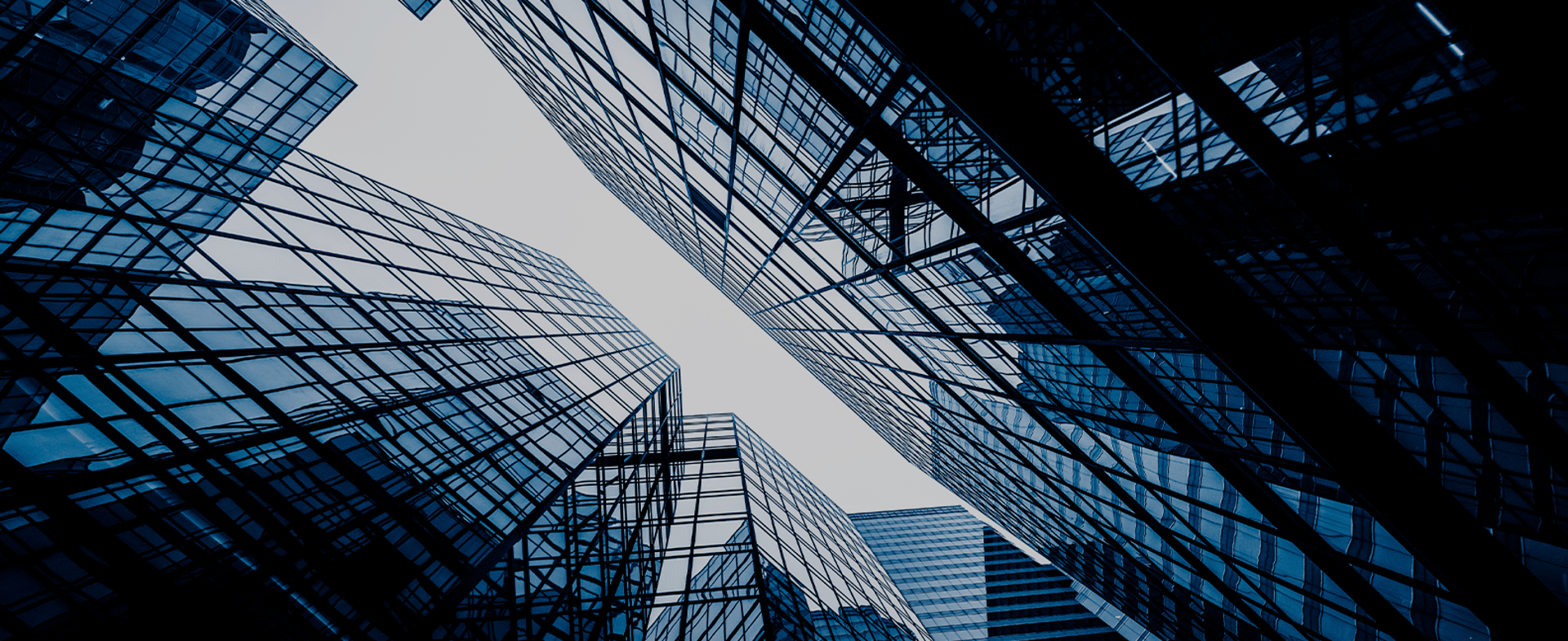 an abstract photo of a curved building with a blue sky in the background