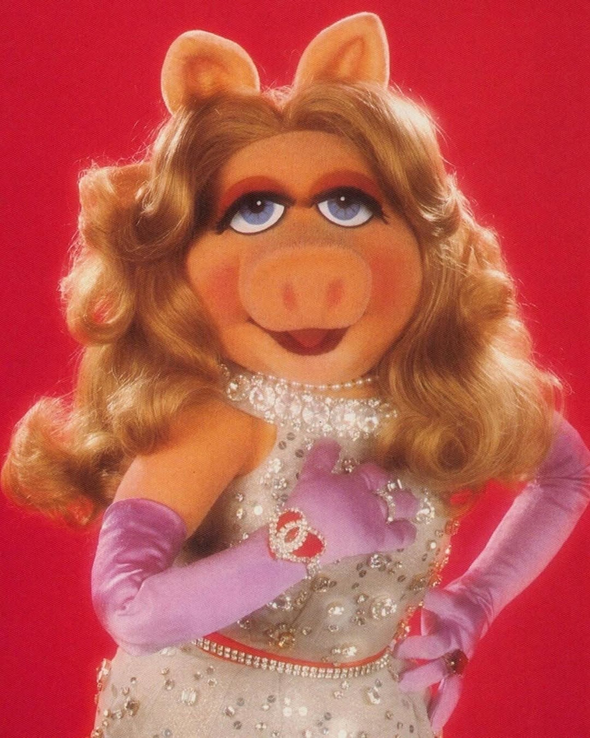 Performer in elaborate costume on stage with dancers