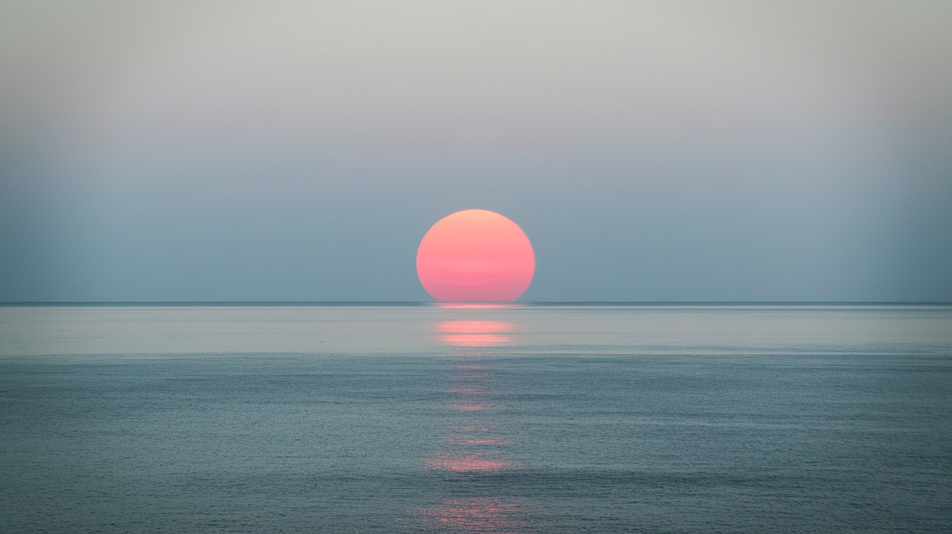 a person standing in the water at sunset