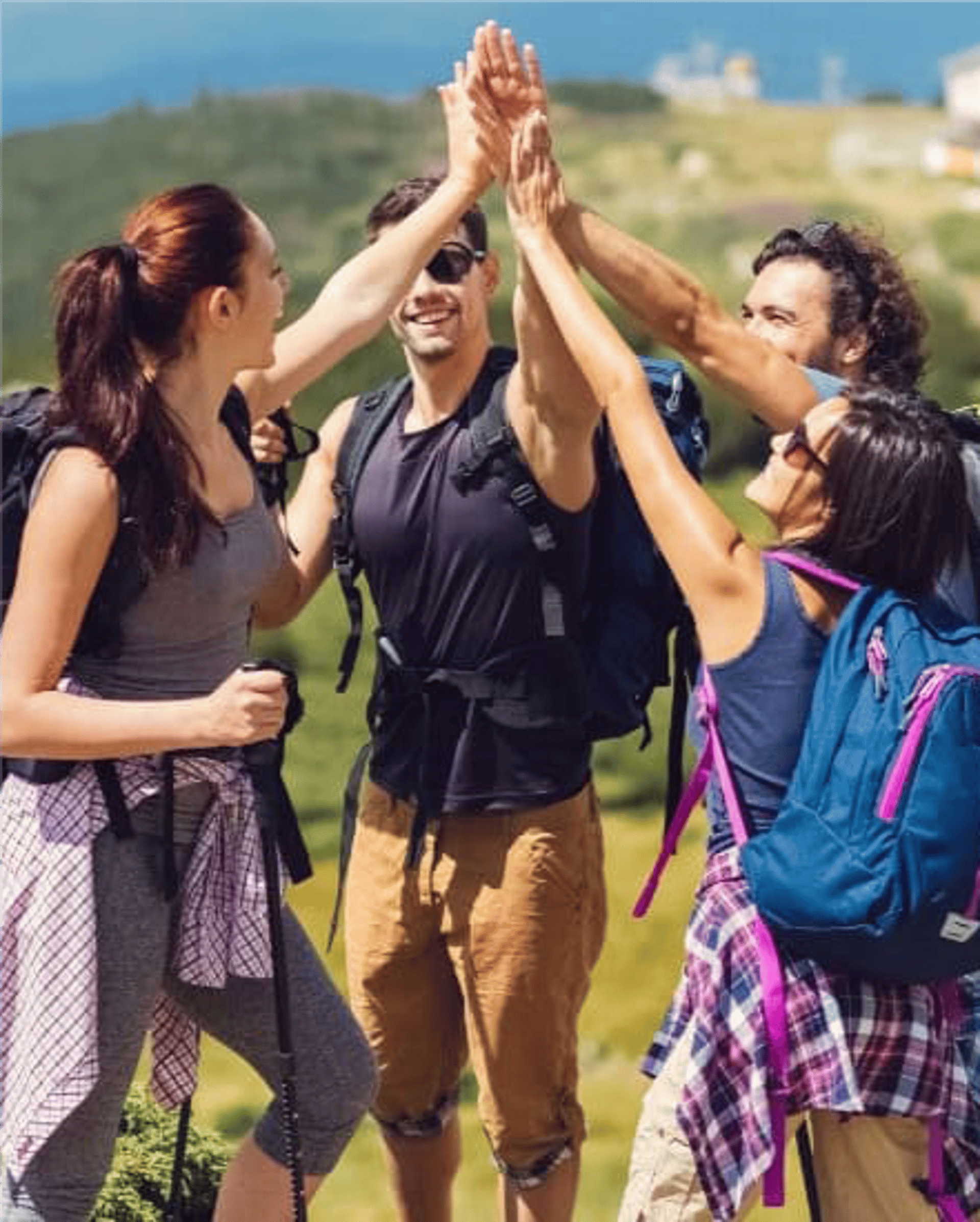 person walking on road near green open field under white skies