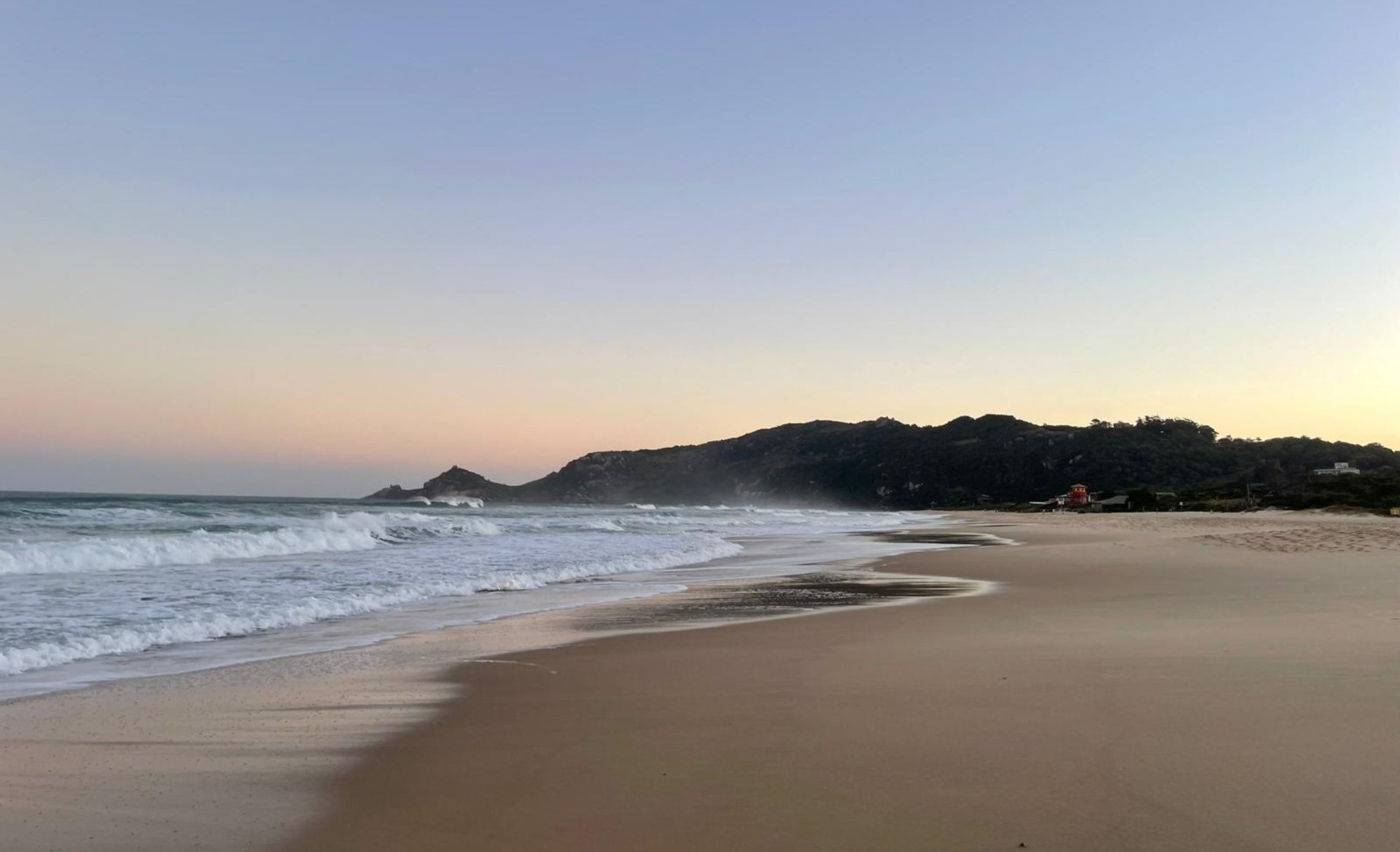 Boats float in a beautiful blue bay.