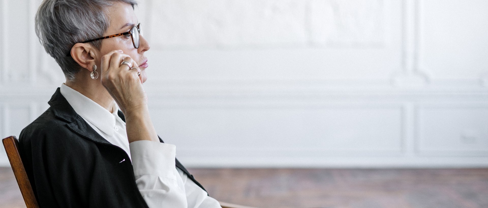 pen near black lined paper and eyeglasses