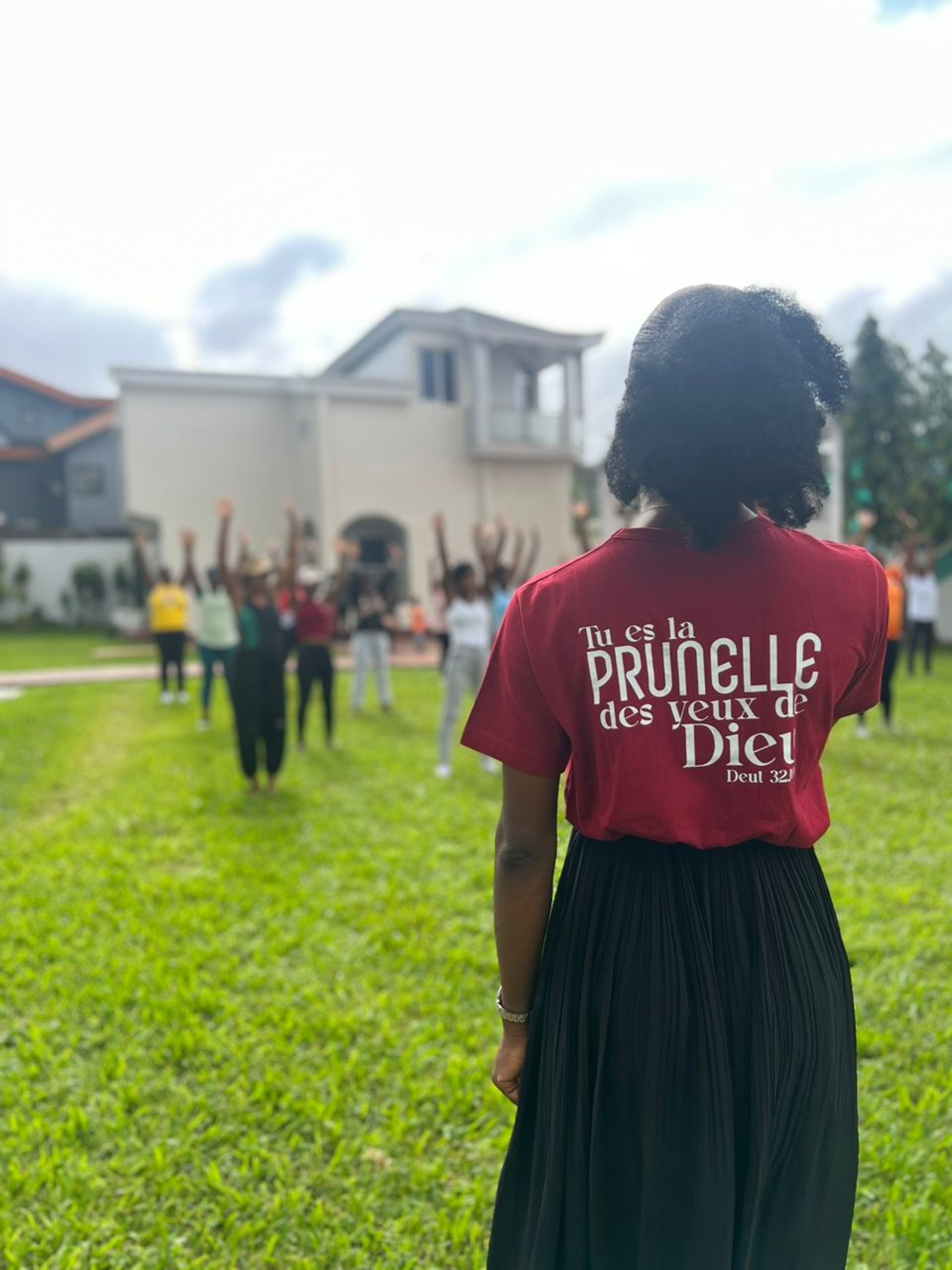 woman wearing yellow long-sleeved dress under white clouds and blue sky during daytime