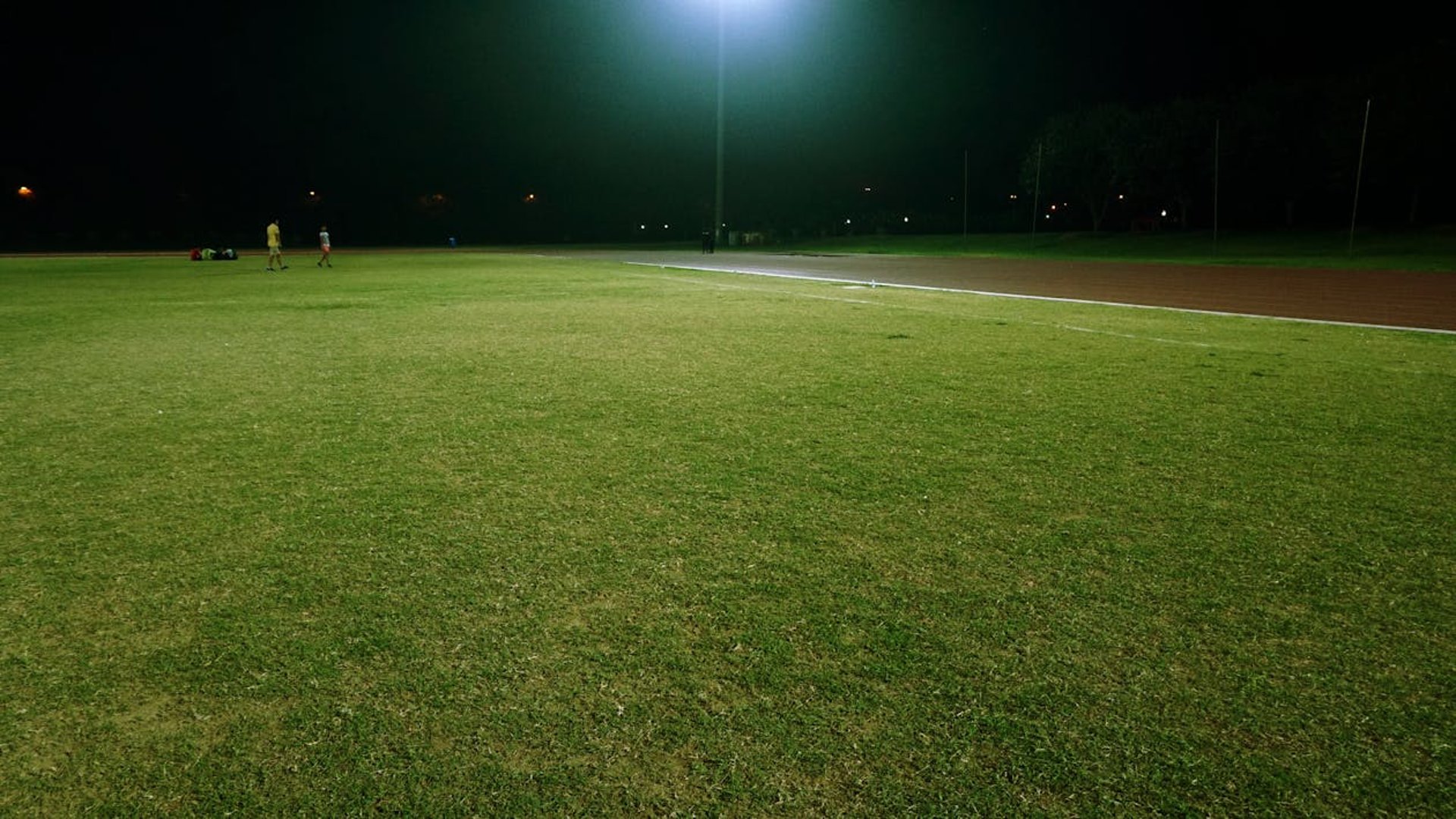 selective focus photography of brown football on grass at daytime