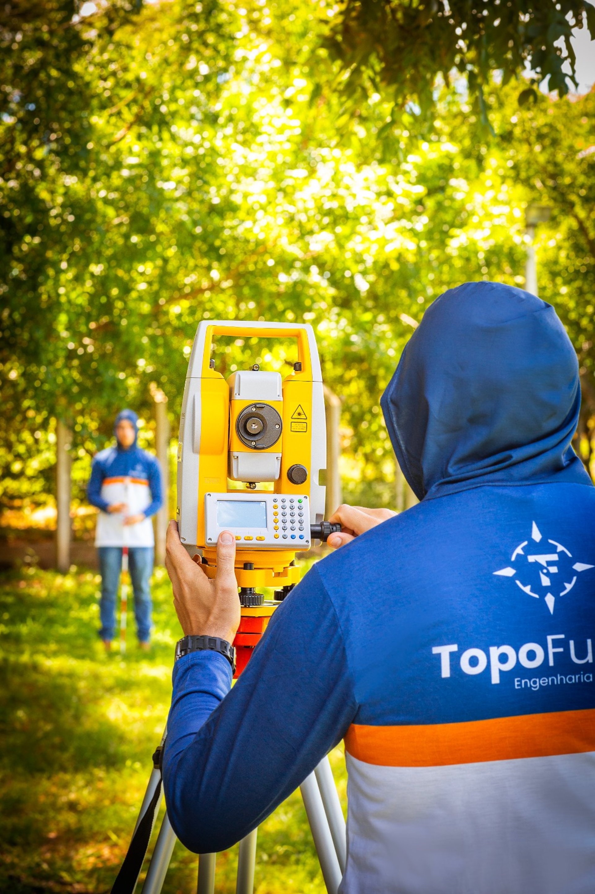 black and white tripod on green grass field during daytime