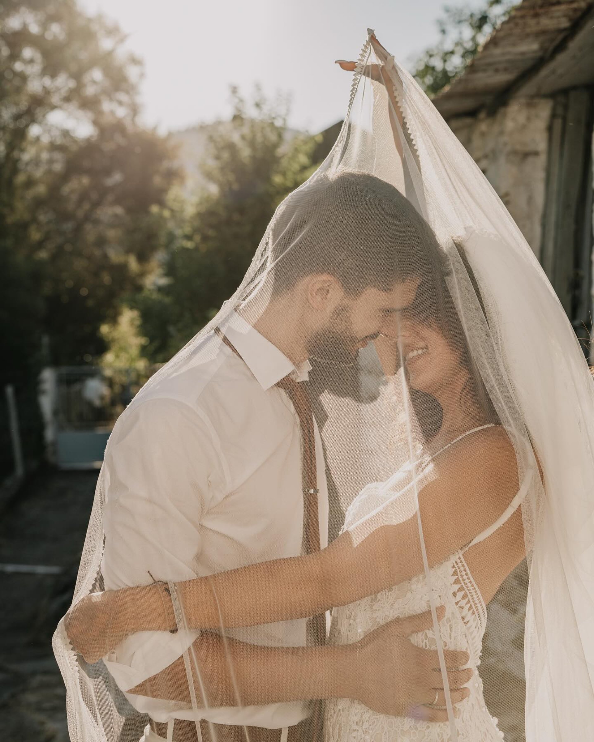 woman in white floral strapless dress holding flowers
