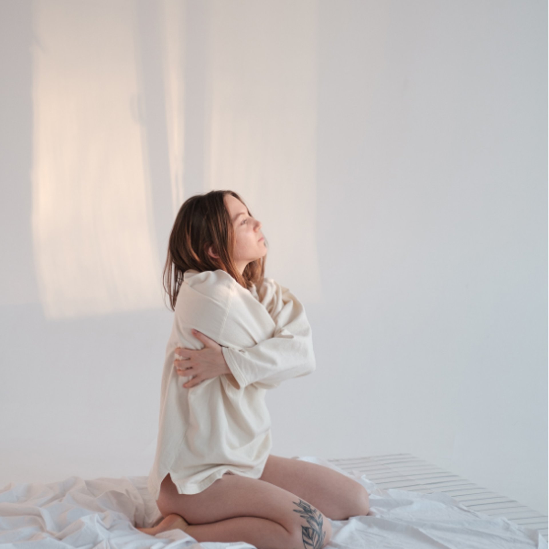 a girl folding her hands around her body