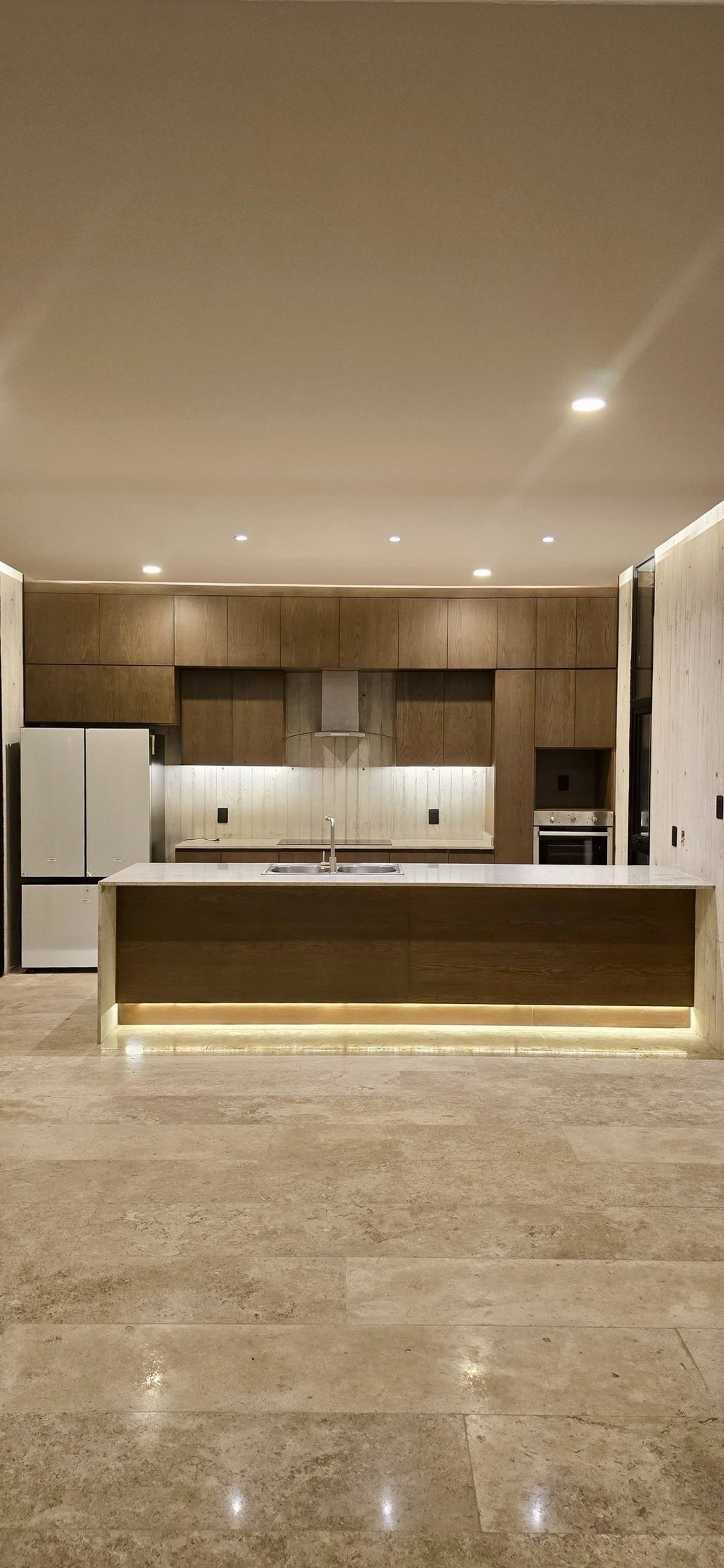 an abstract photo of a curved building with a blue sky in the background