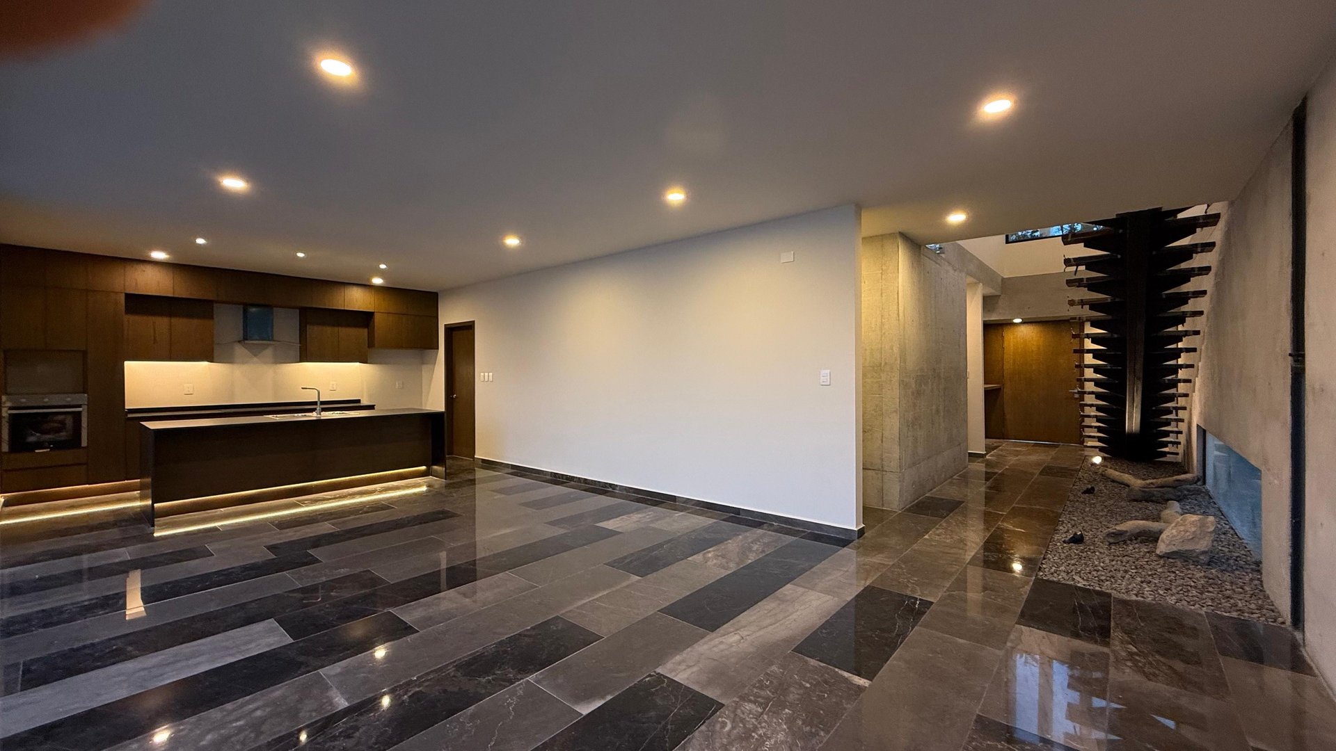 an abstract photo of a curved building with a blue sky in the background