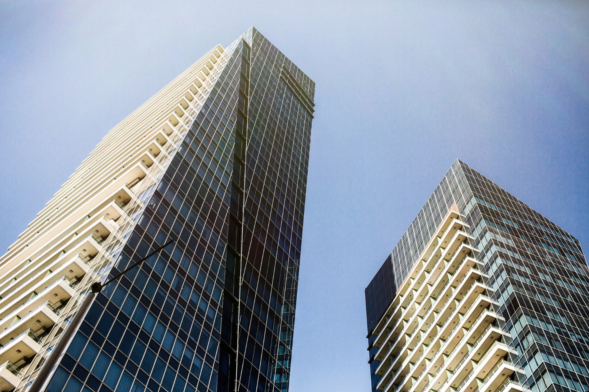 an abstract photo of a curved building with a blue sky in the background