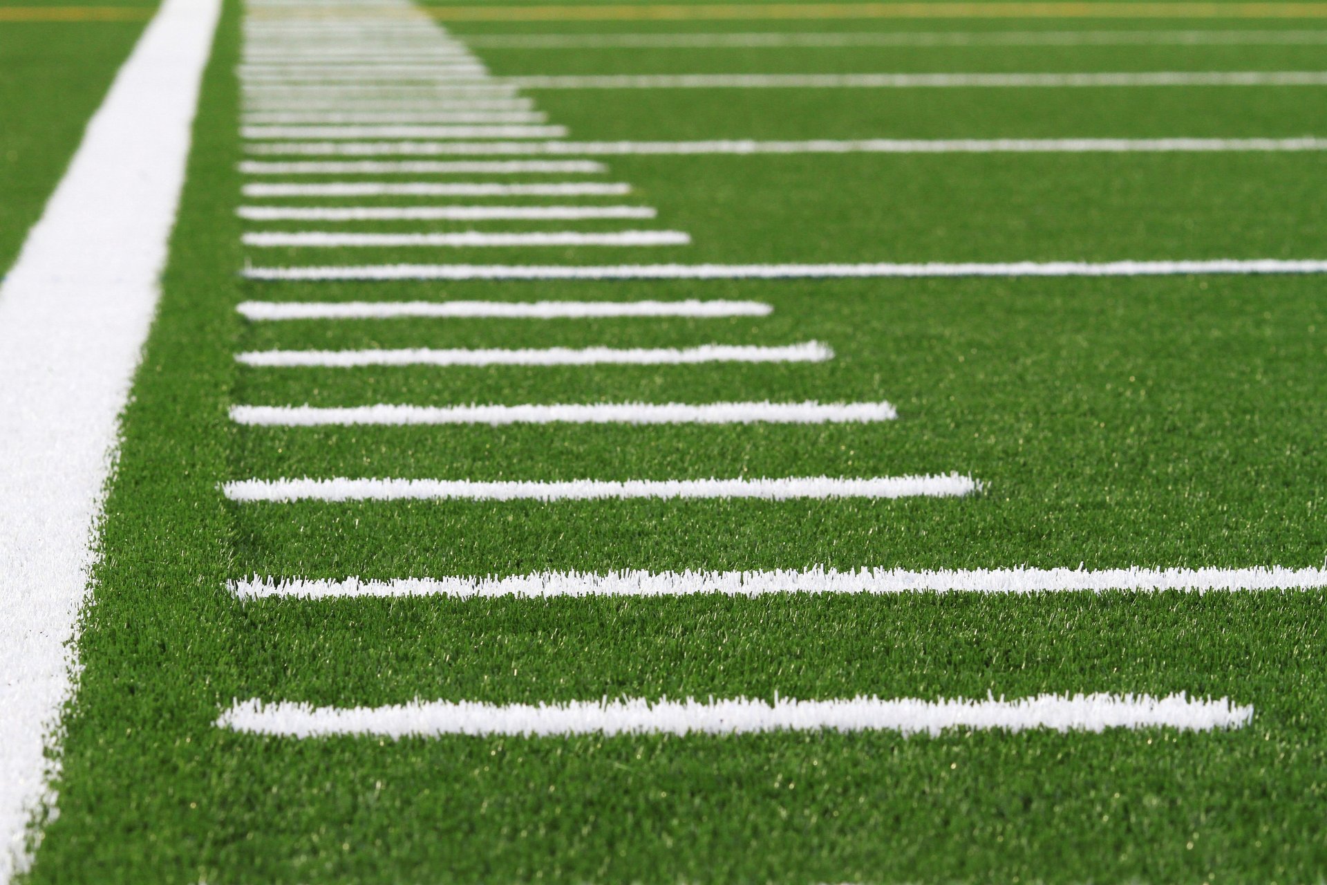 A football laying on a football field