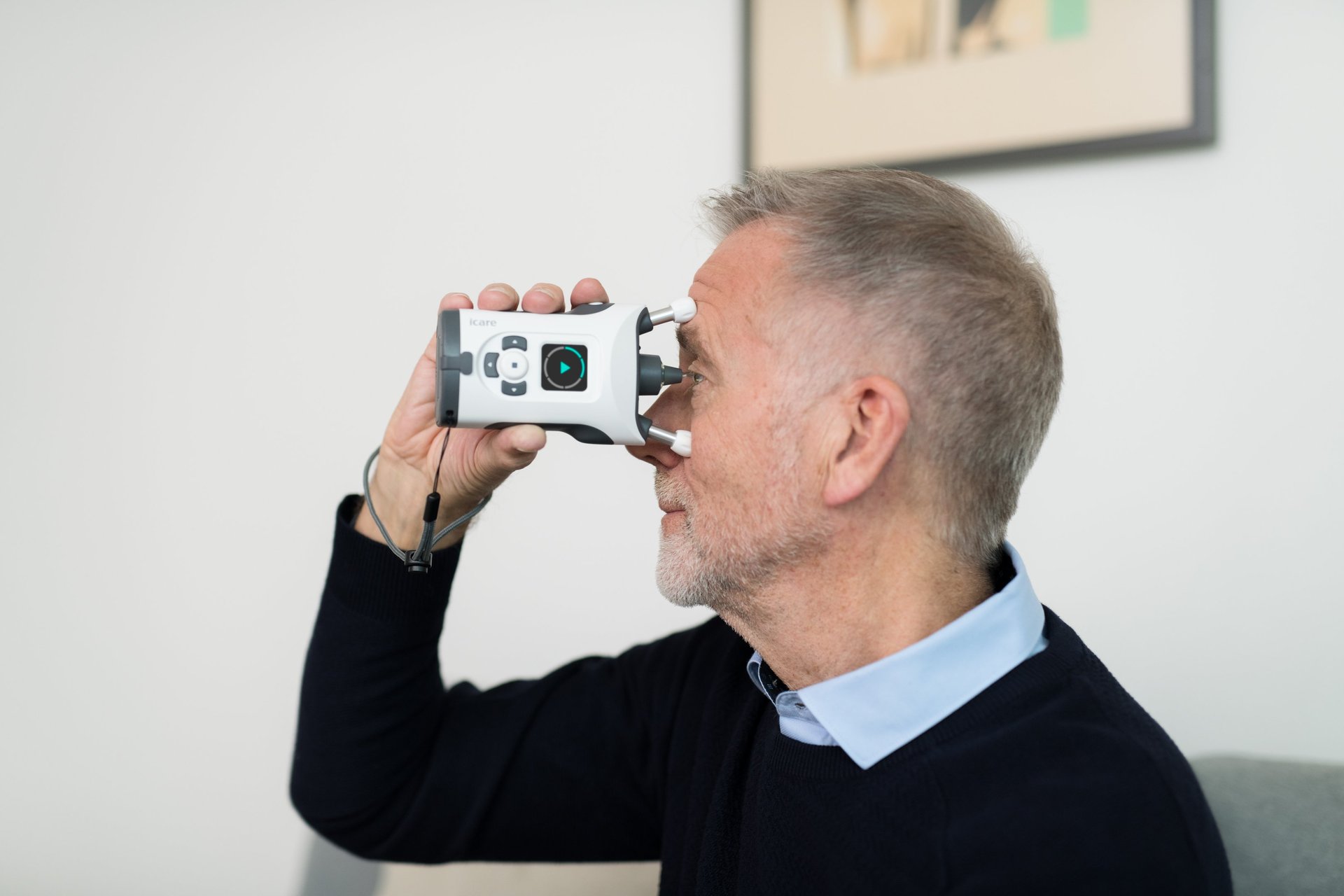 Man measuring hiw own eye pressure IOP with an iCare HOME2 tonometer.