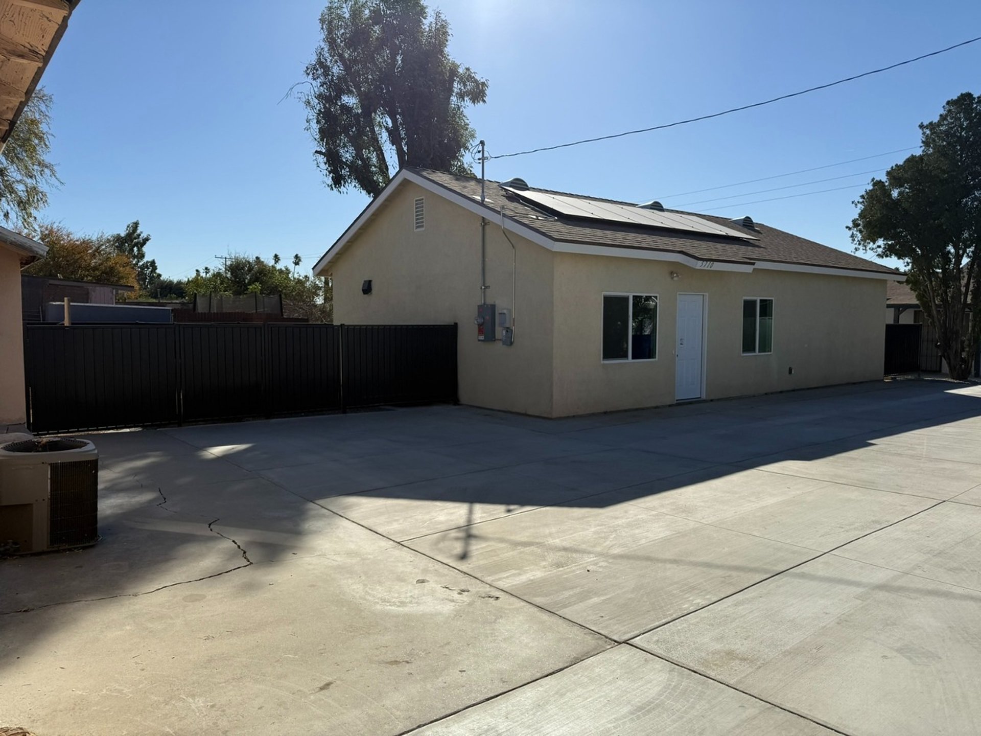 A man sanding a wooden table with a sander