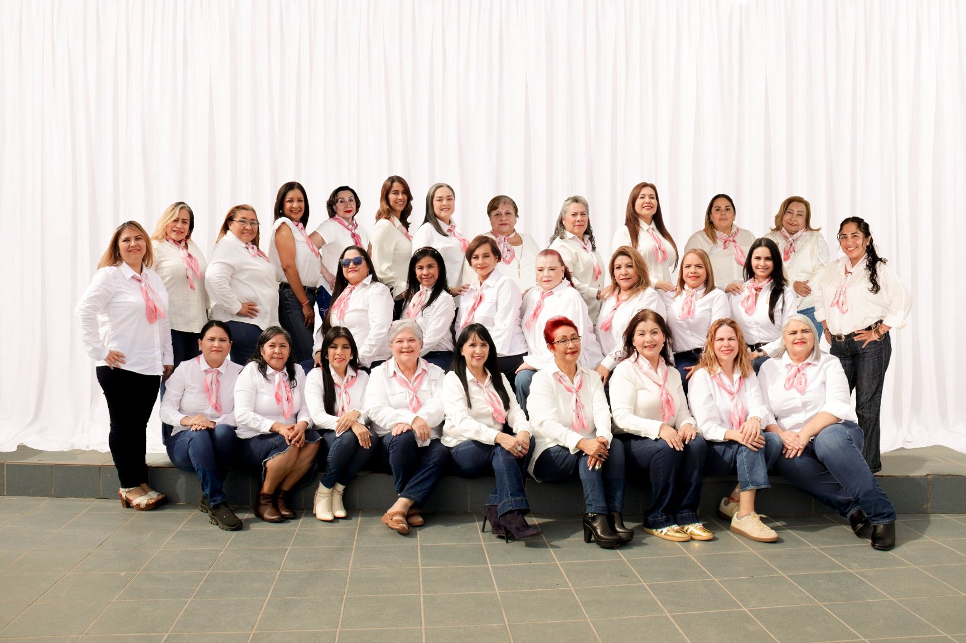 four person holding each others waist at daytime