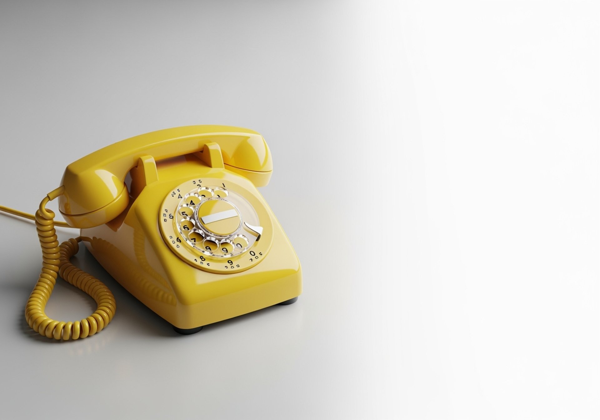 red and white rotary phone on brown wooden table