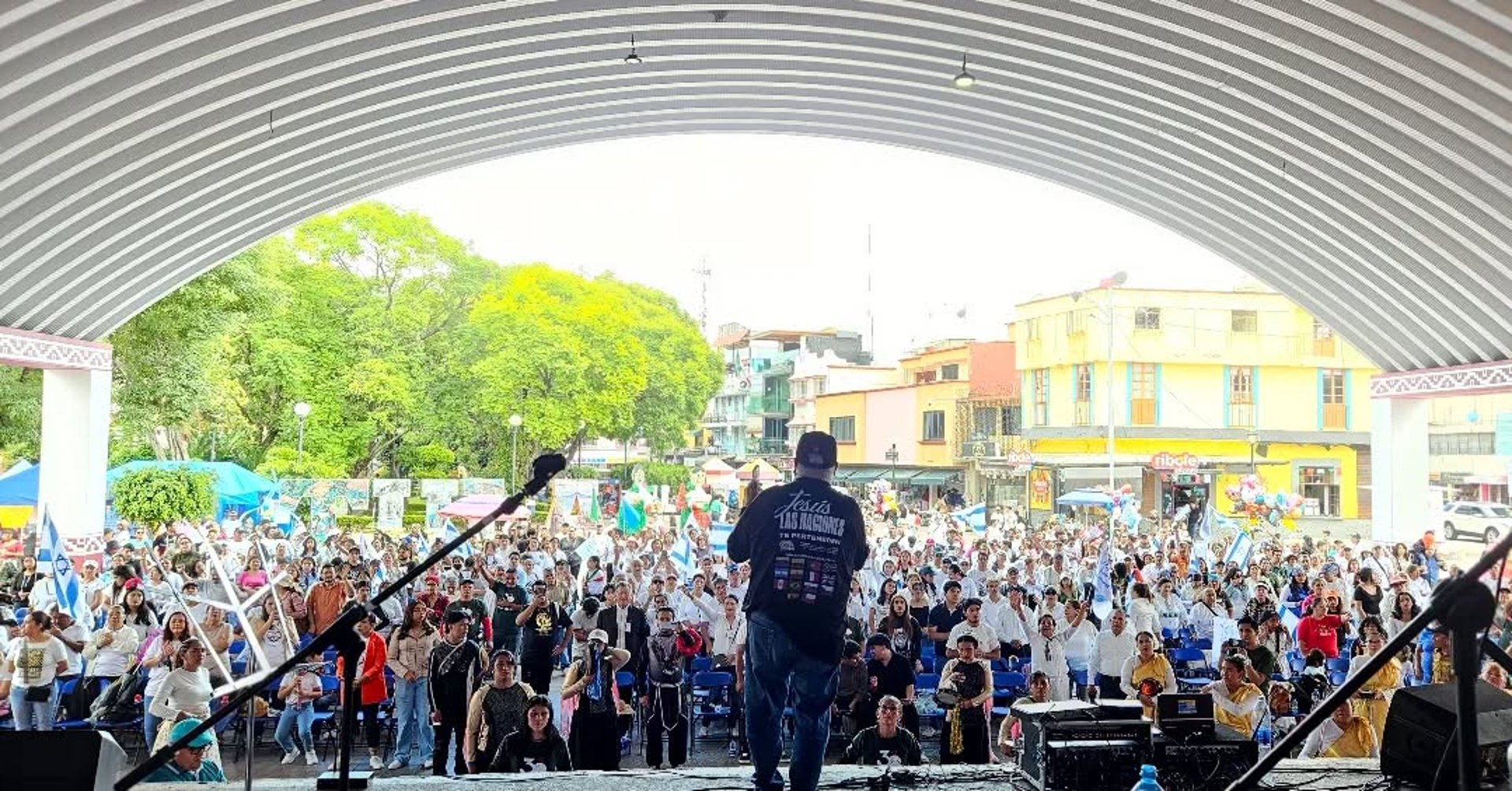 a large stone building with flags on top with National Palace in the background