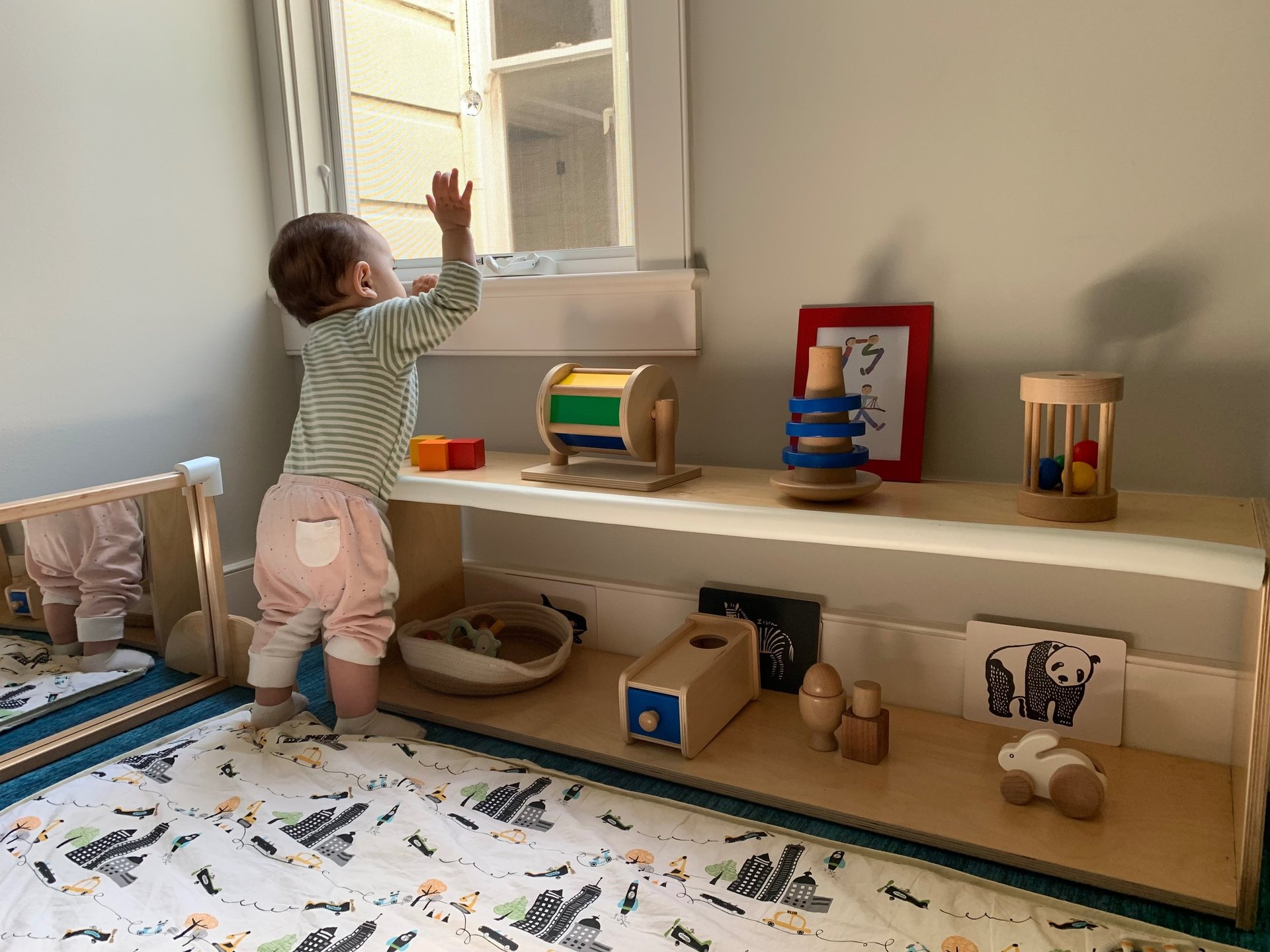 toddler wearing white tank top near white wall