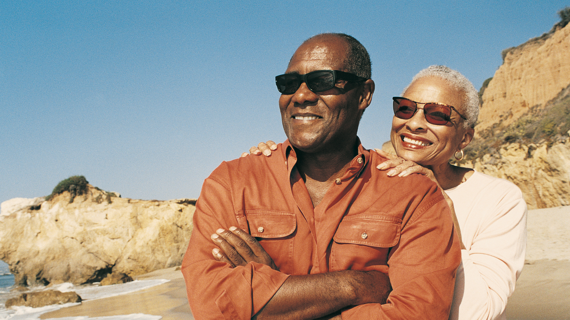 a woman sitting at a table with a laptop