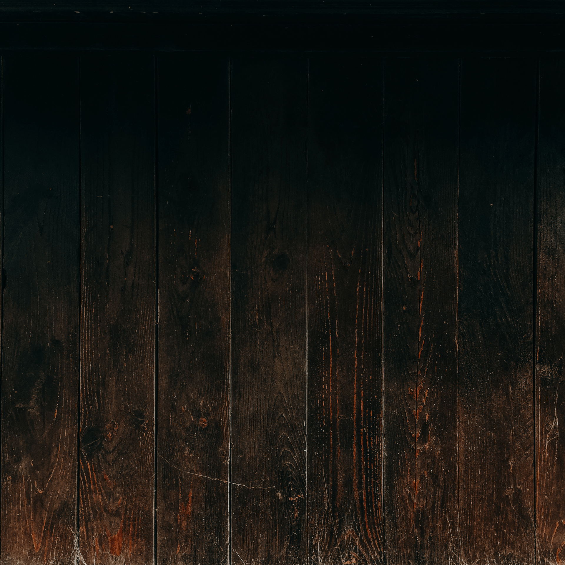 a close up of a wooden wall with a light shining on it