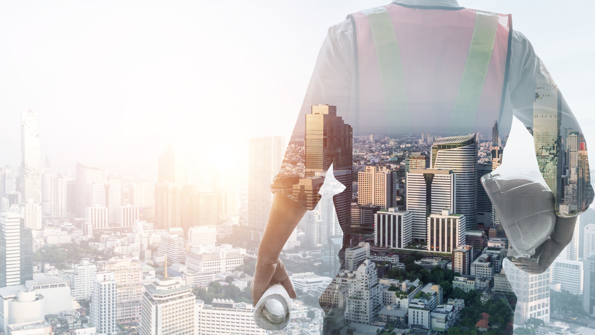 a man in an orange vest is working on a concrete block