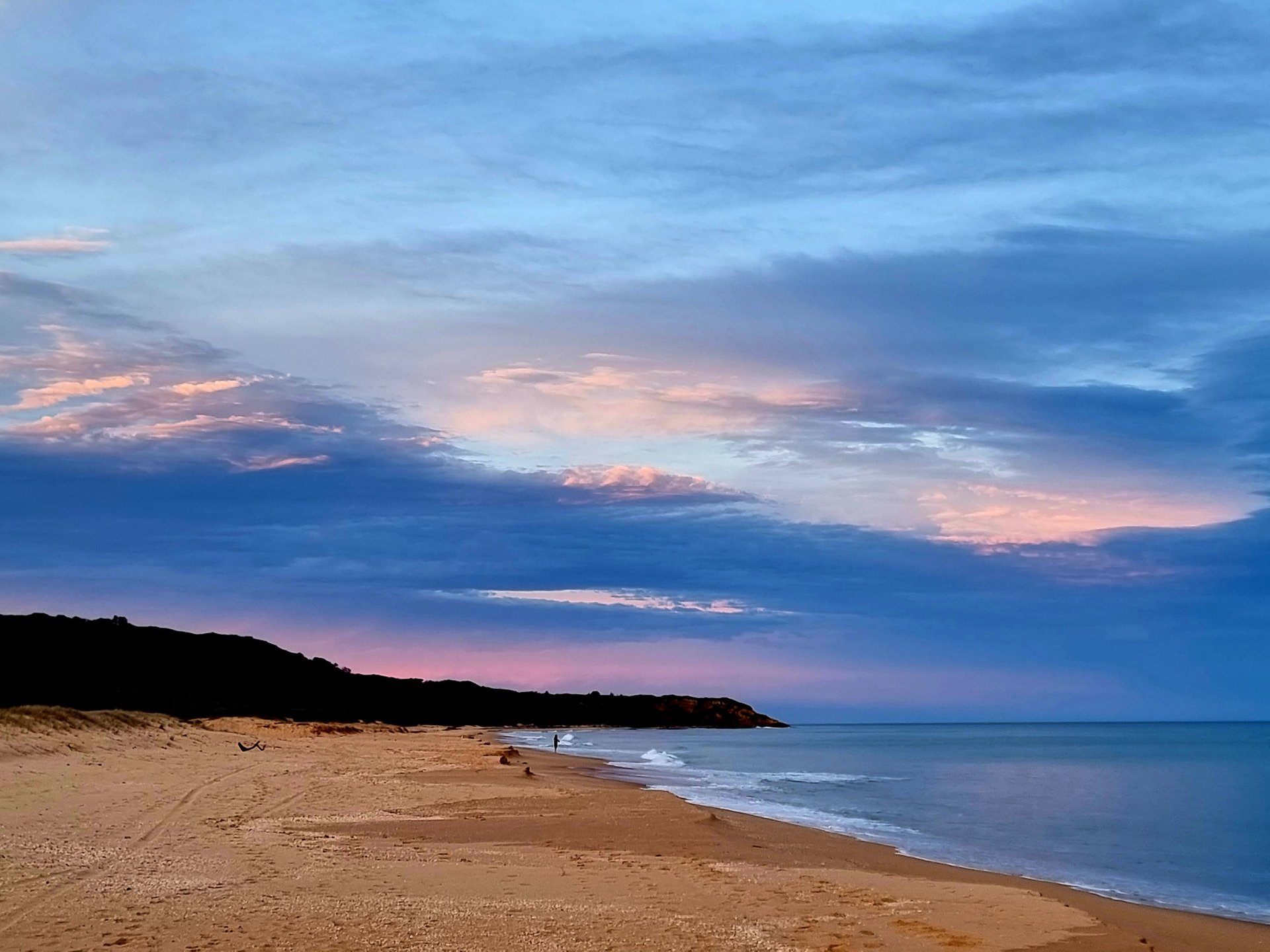 woman wearing yellow long-sleeved dress under white clouds and blue sky during daytime
