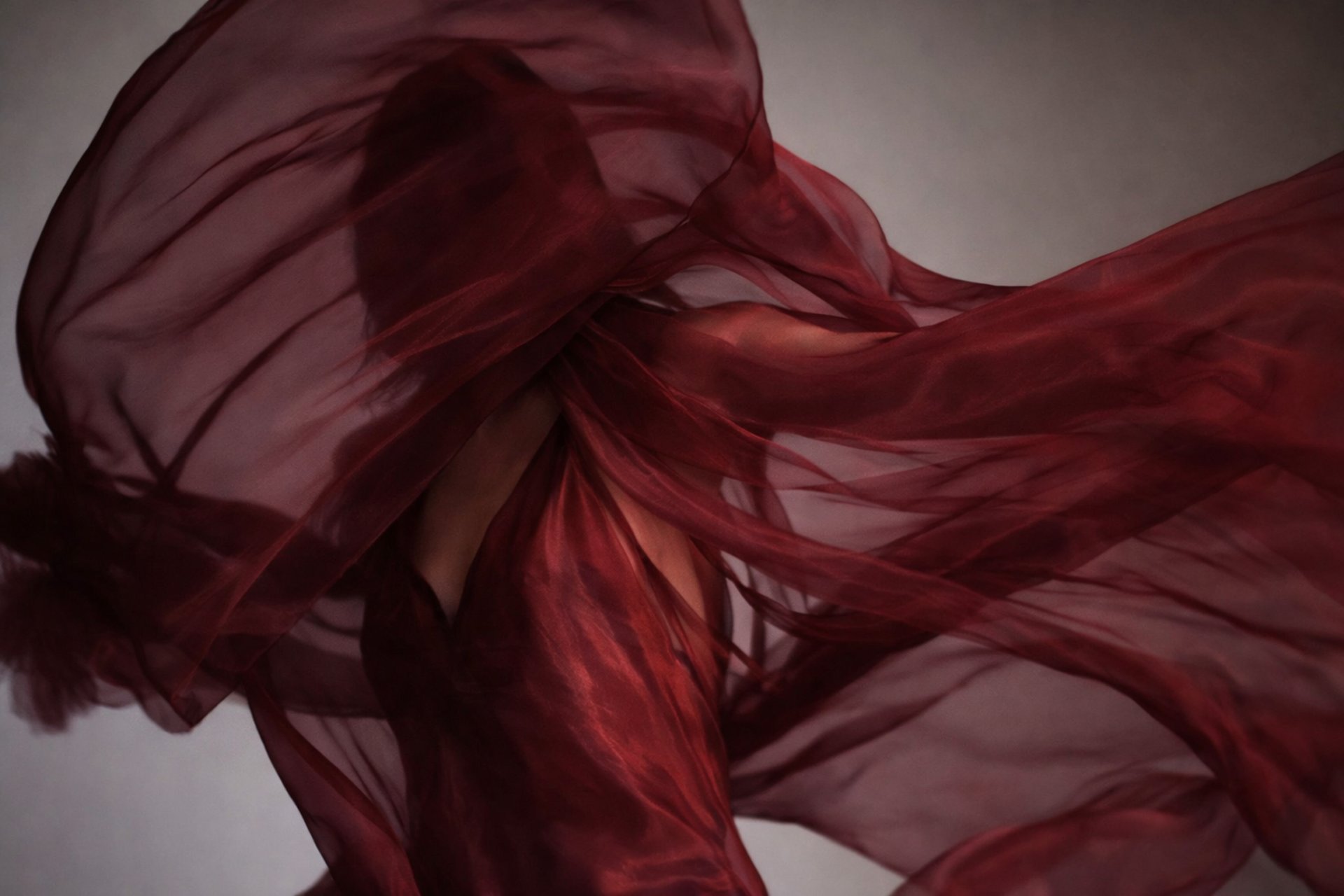 an abstract photo of a curved building with a blue sky in the background