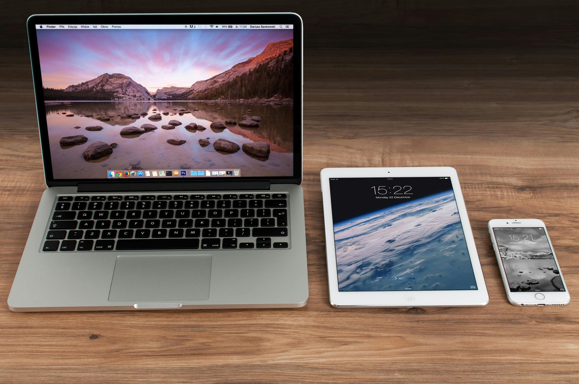 MacBook Pro on table beside white iMac and Magic Mouse