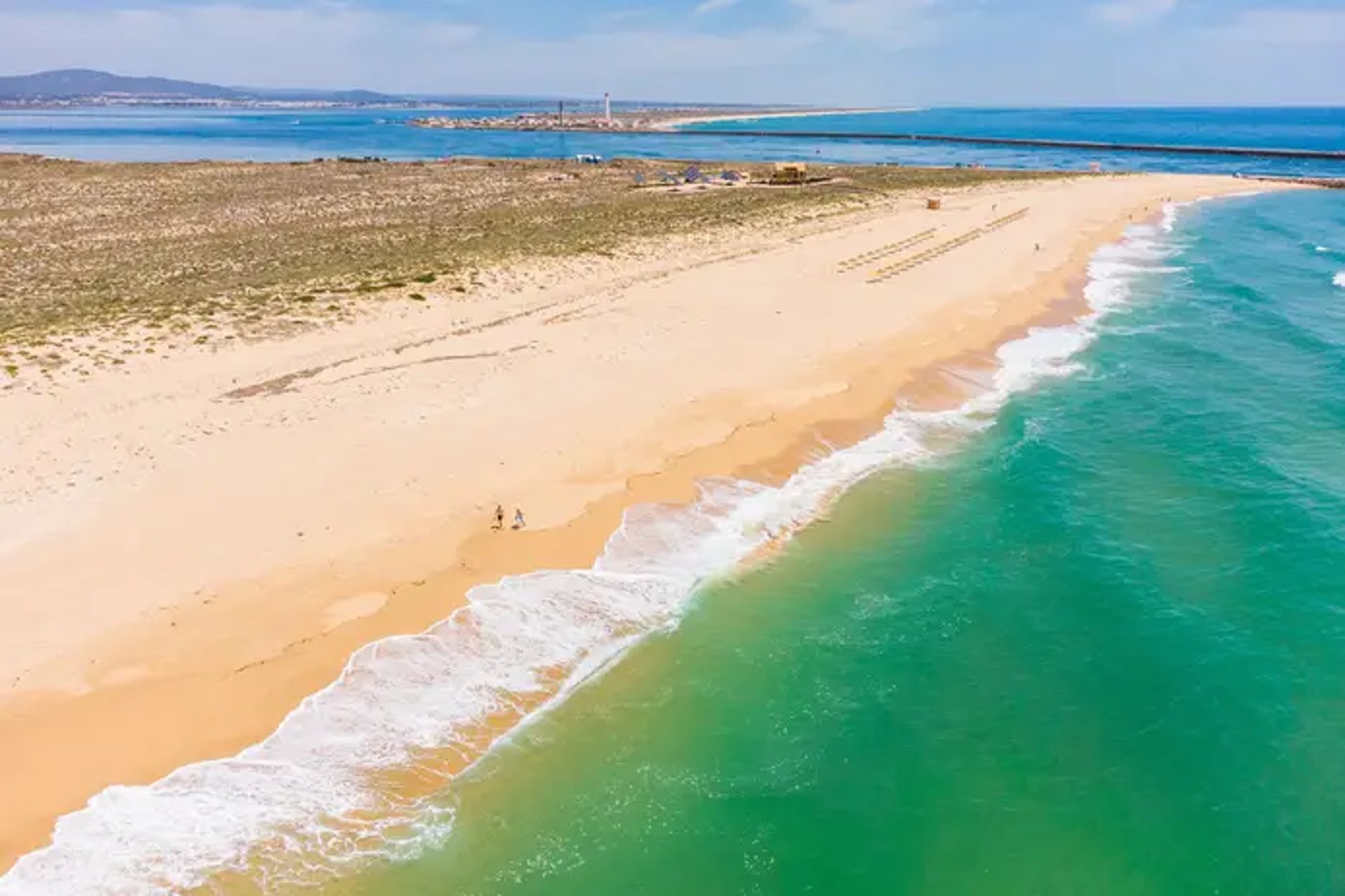 woman wearing yellow long-sleeved dress under white clouds and blue sky during daytime