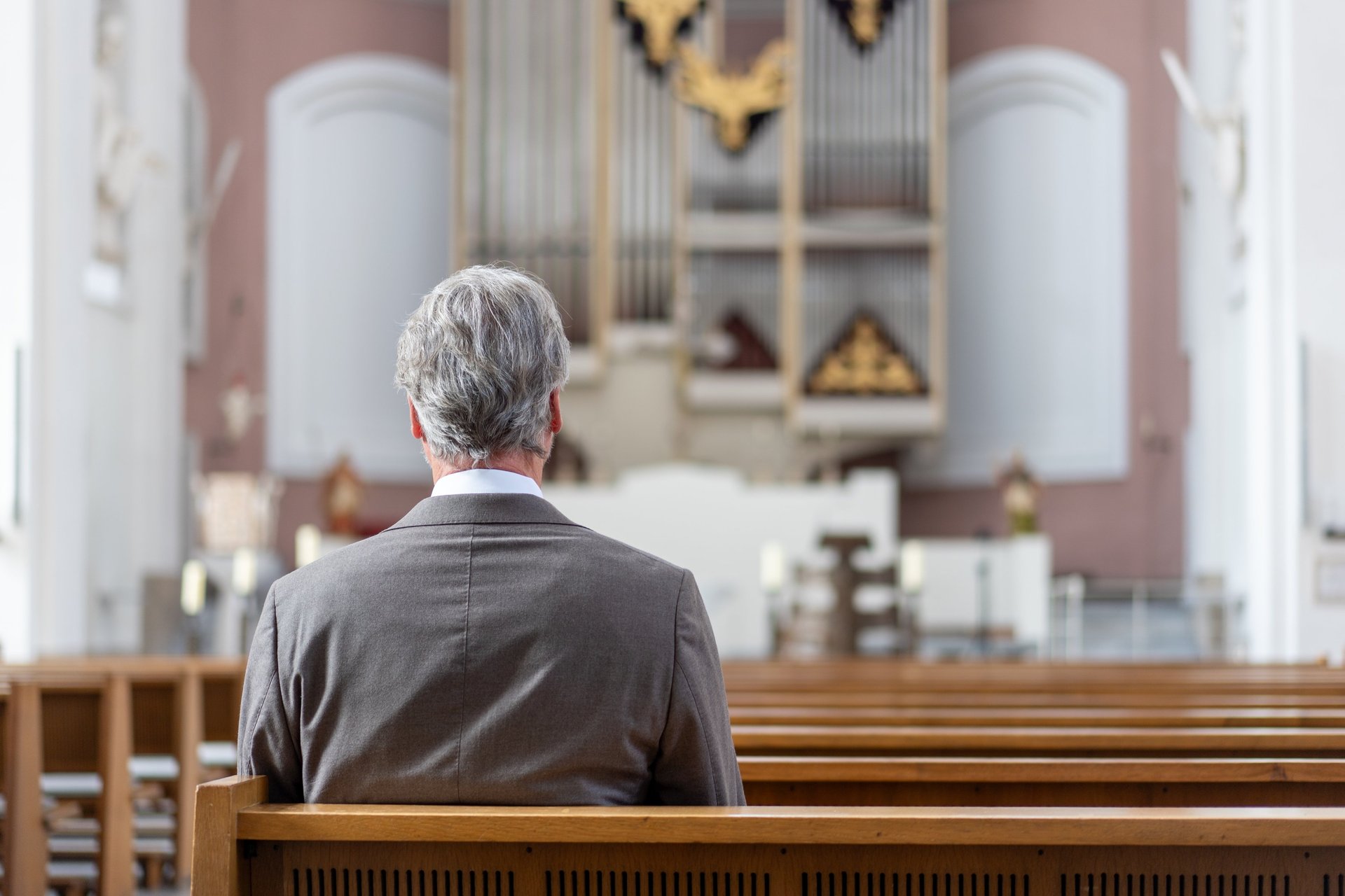 an abstract photo of a curved building with a blue sky in the background