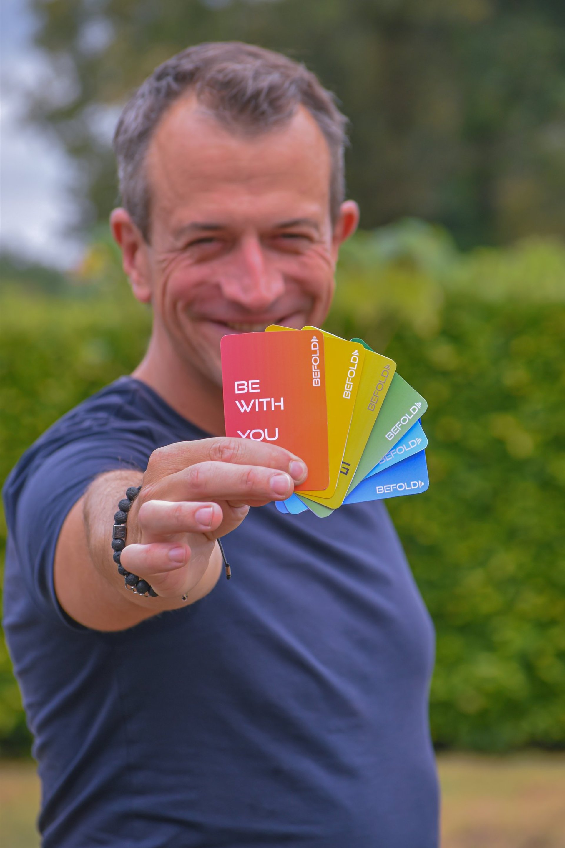 man sitting on chair underwater with floating bottles