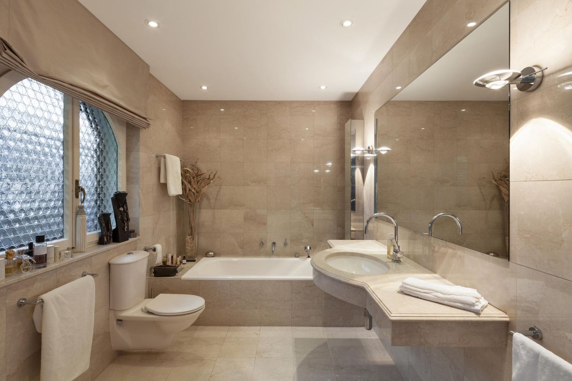 a bathroom with a toilet, sink, and bathtub