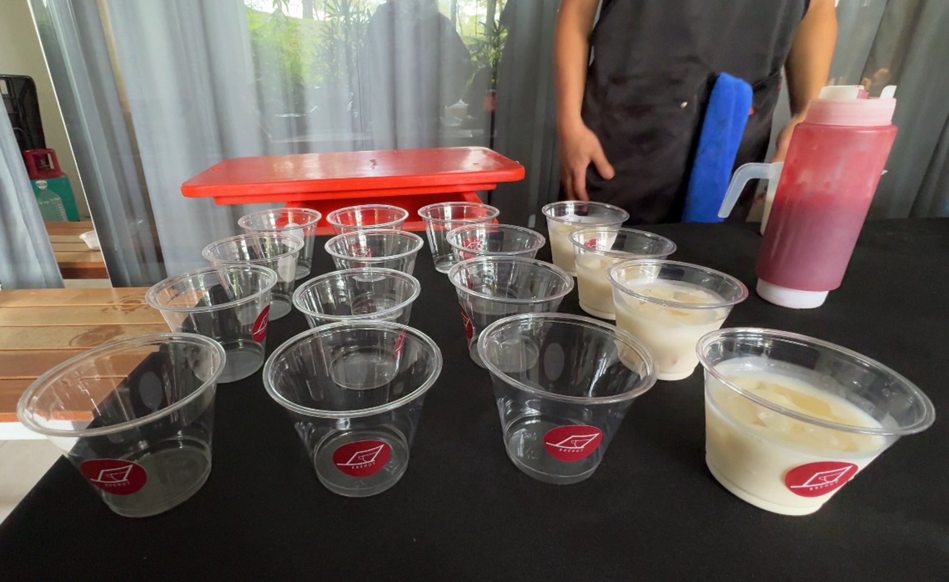 a shelf filled with orange cups sitting next to each other