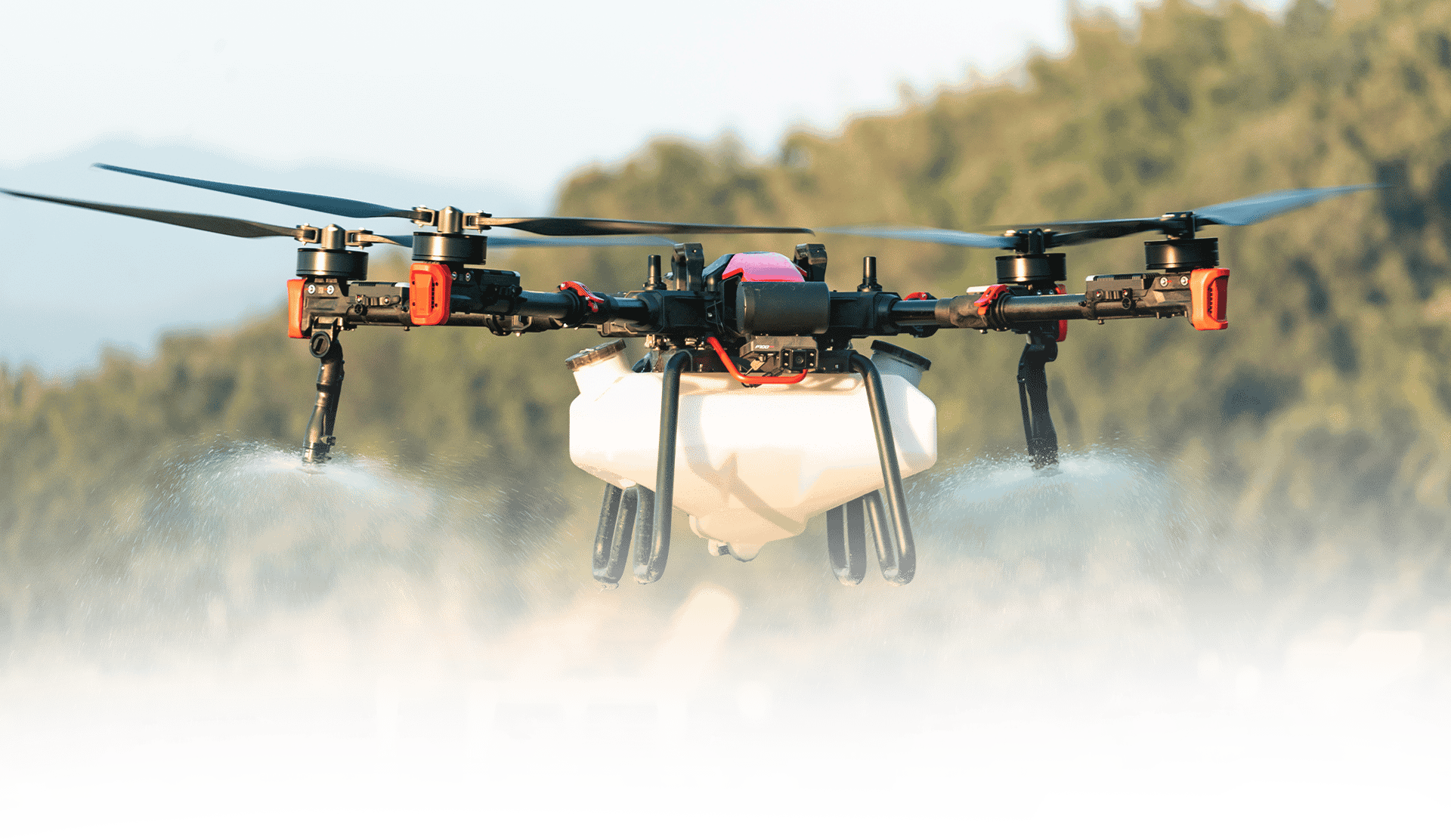 A helicopter spraying water on a field of green grass