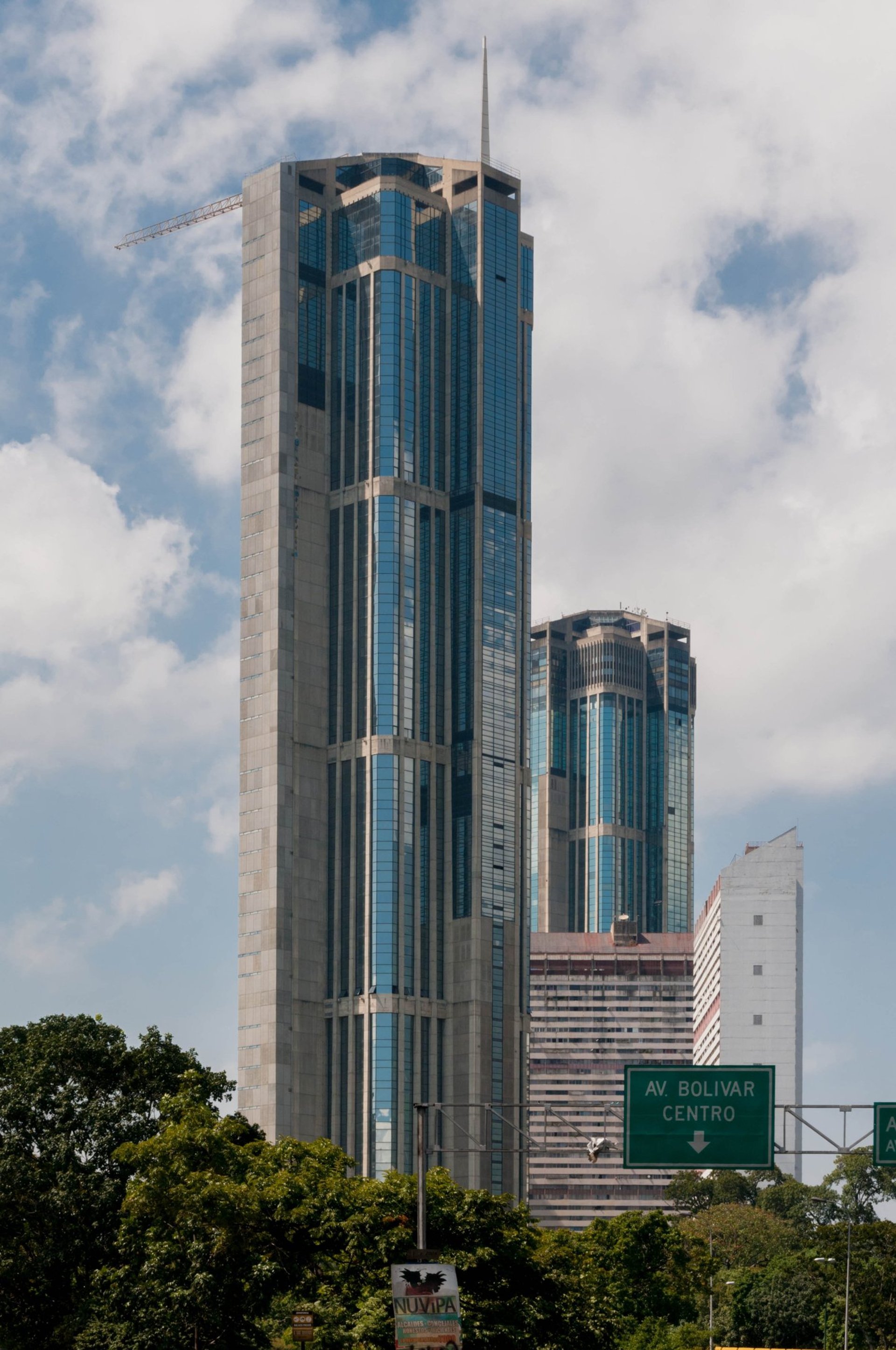 an abstract photo of a curved building with a blue sky in the background