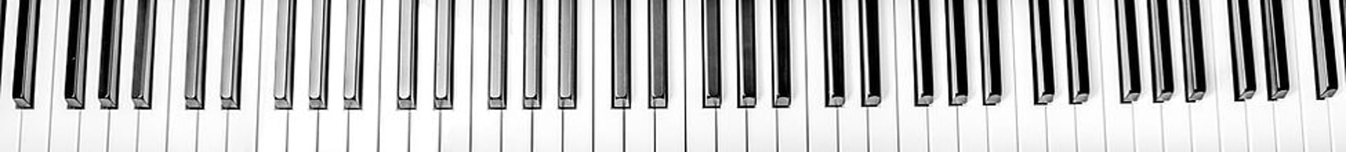 person playing red and white piano