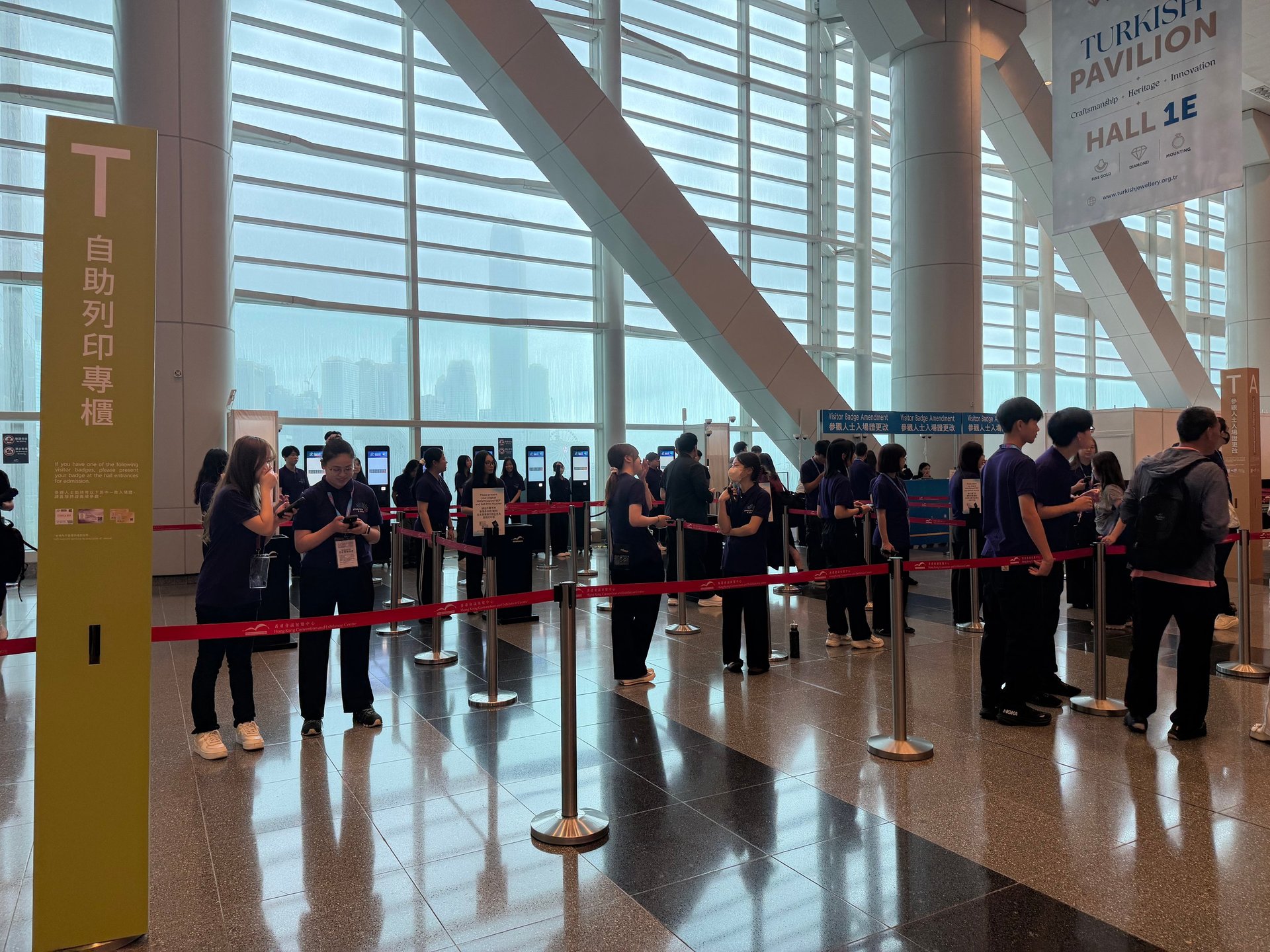 Self-service registration kiosk issuing a printed badge at JGA Hong Kong 2026