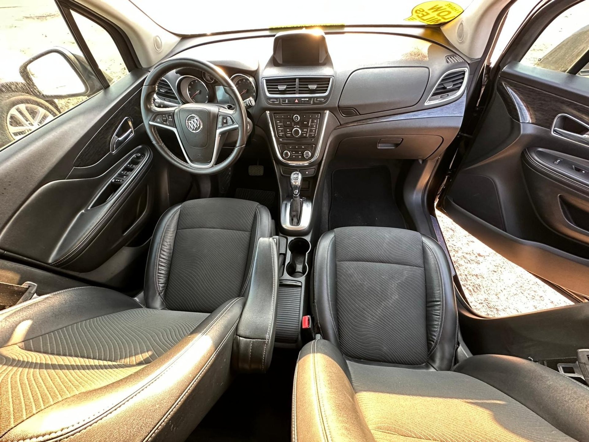 man refilling motor oil on car engine bay