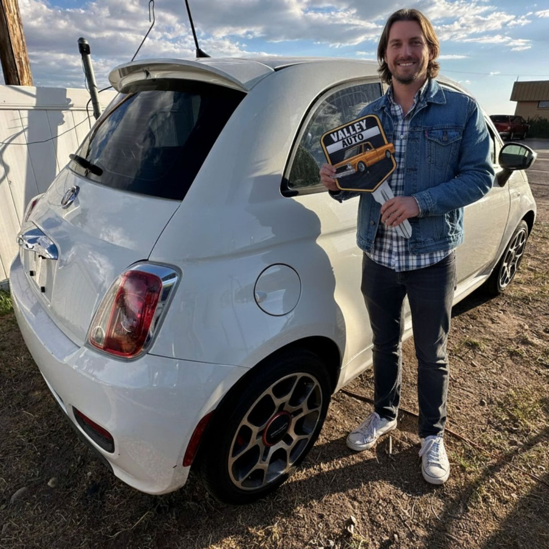 woman wearing yellow long-sleeved dress under white clouds and blue sky during daytime