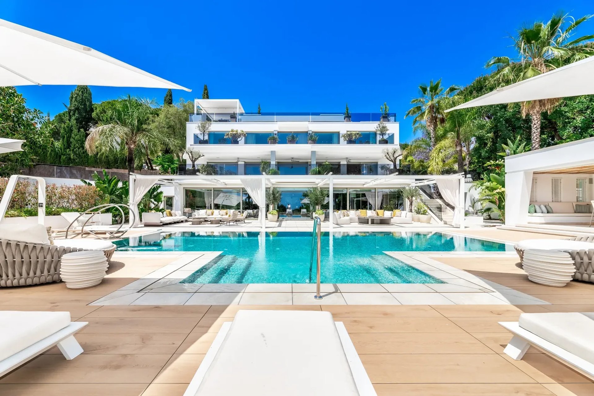 Infinity pool with sun loungers at Villa Serenity Marbella