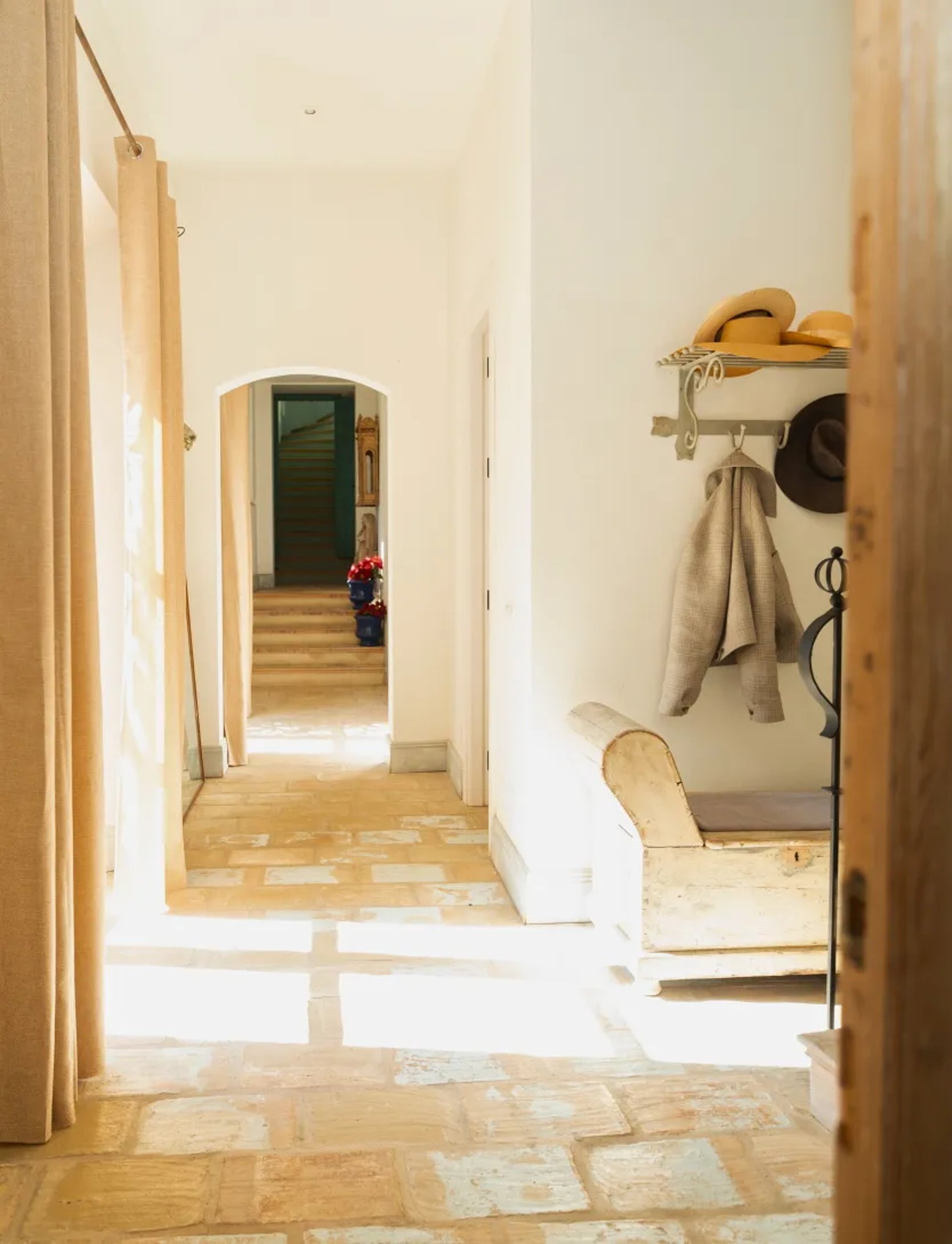 Stone hallway with arched doorway at Finca Santa Katerina