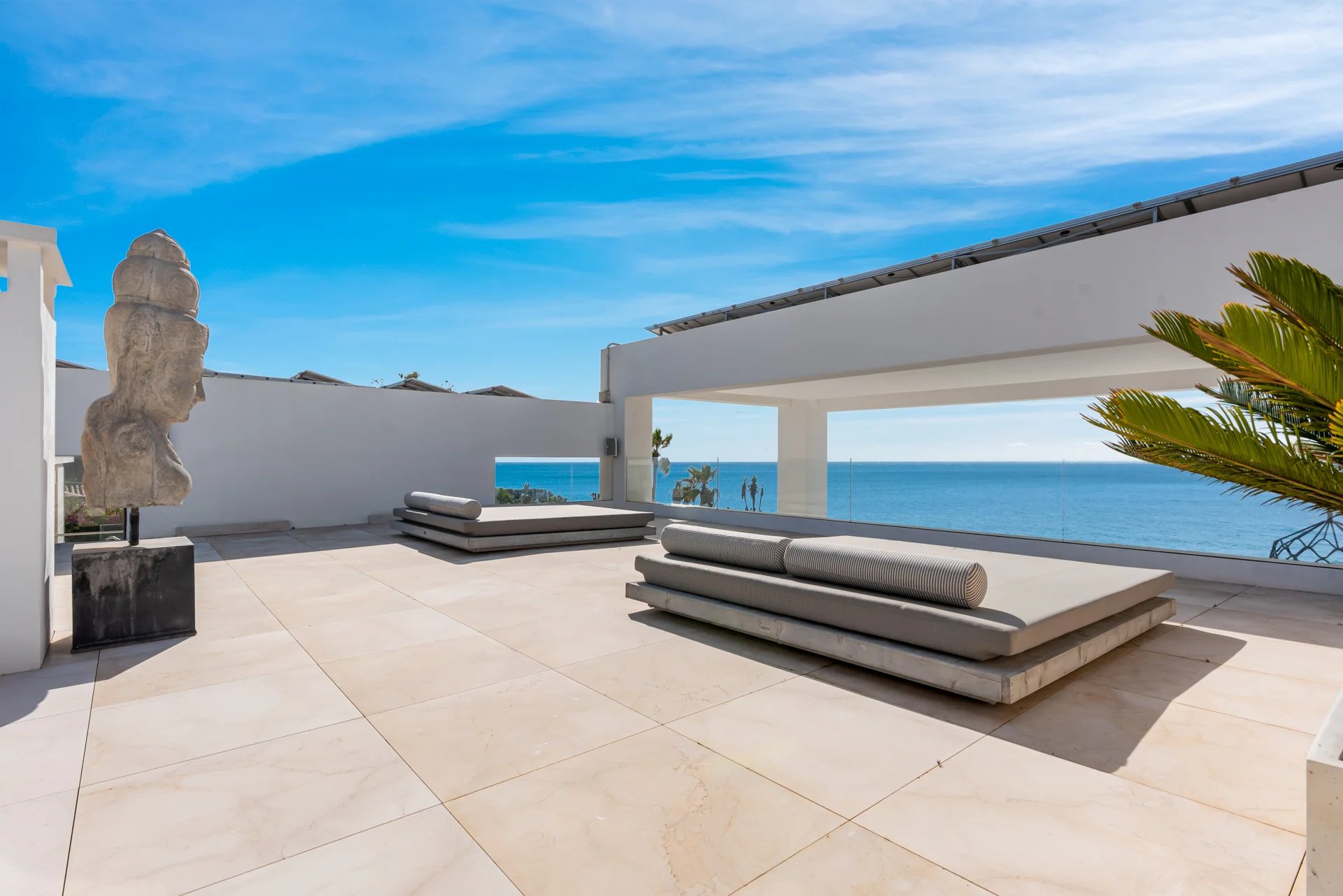Upper terrace lounge with sunbeds and Mediterranean outlook