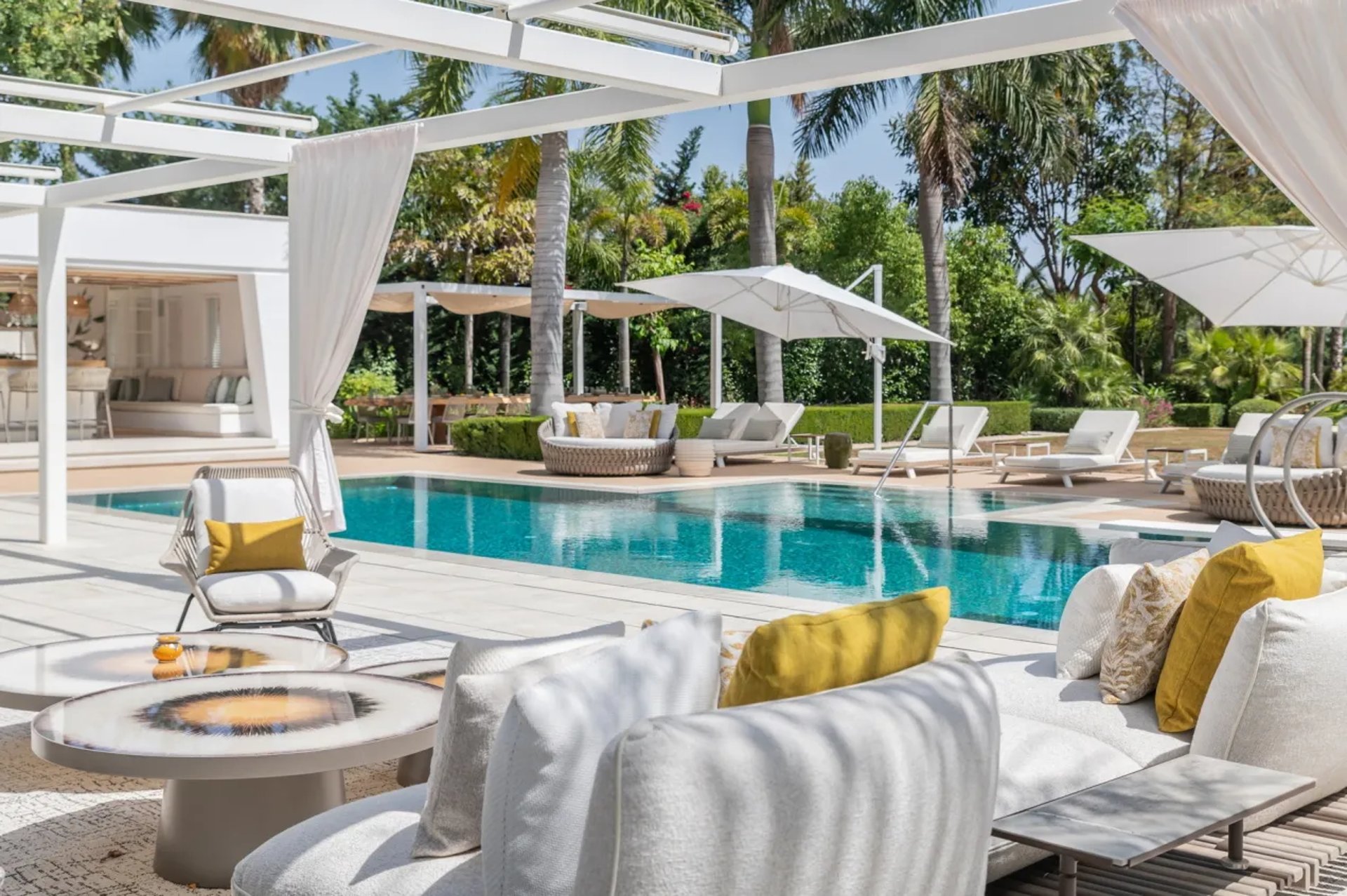 Stylish pool lounge with daybeds at Villa Serenity Marbella