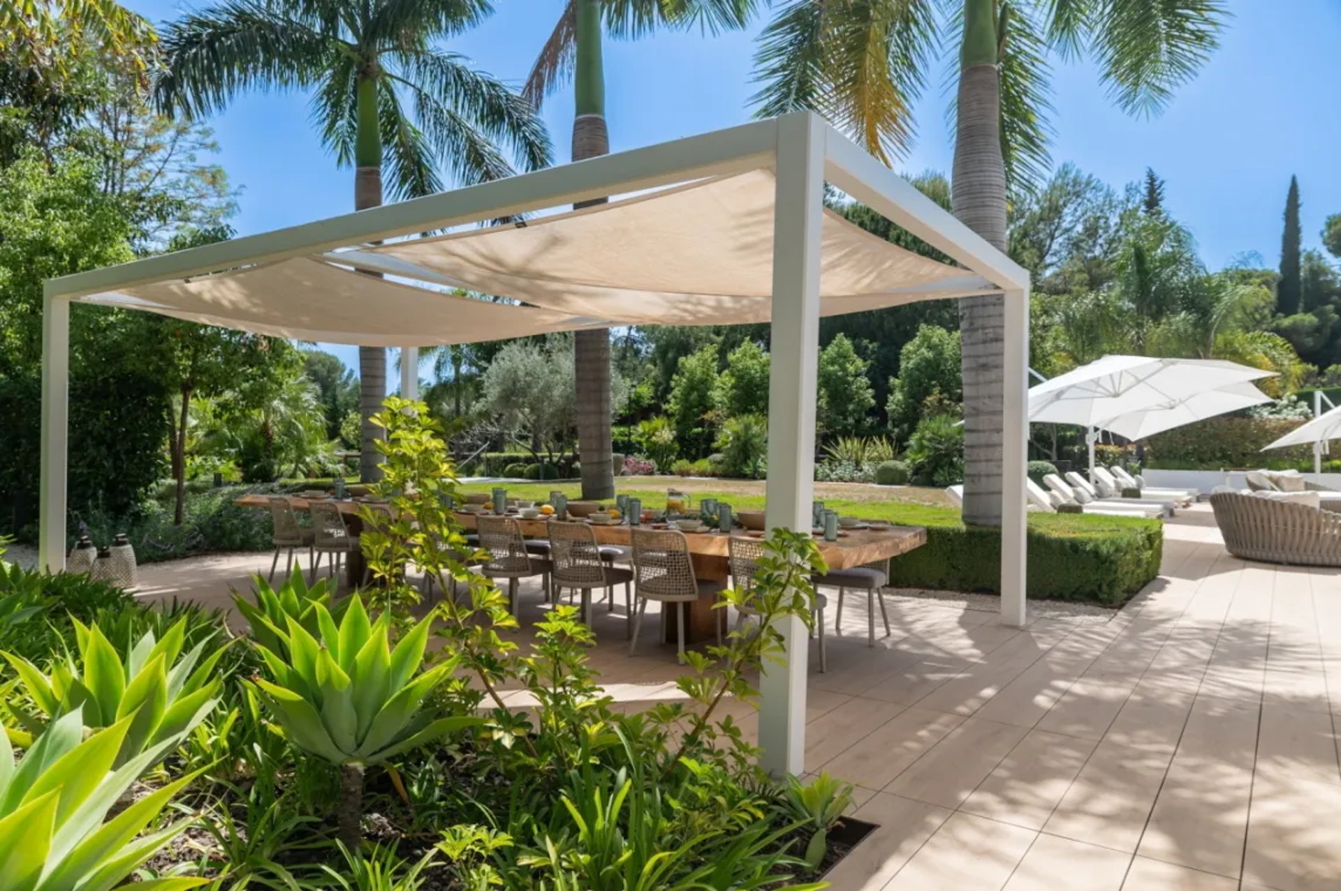 Shaded garden terrace with pergola at Villa Serenity