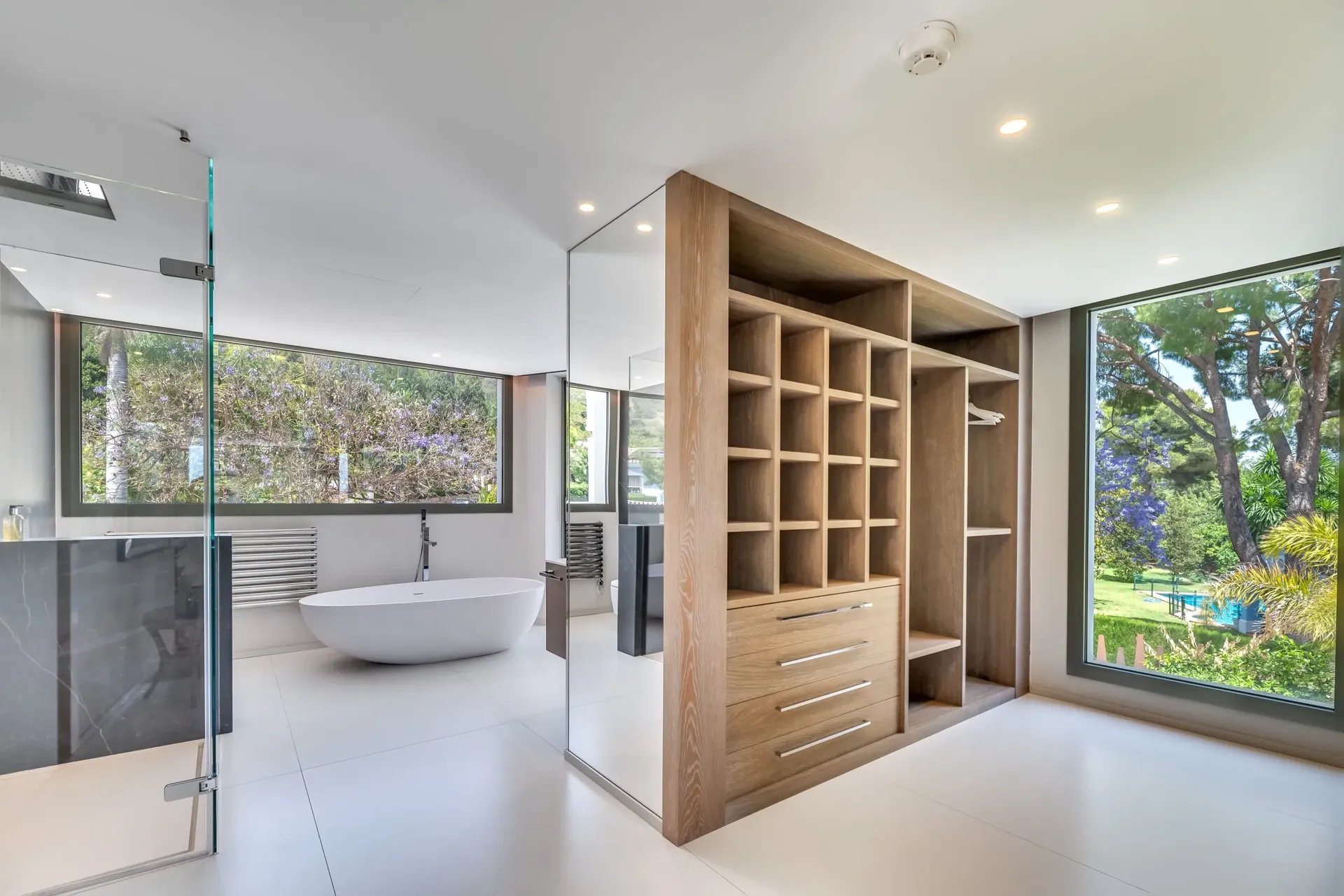 Villa Serenity bathroom with wood cabinetry and garden views